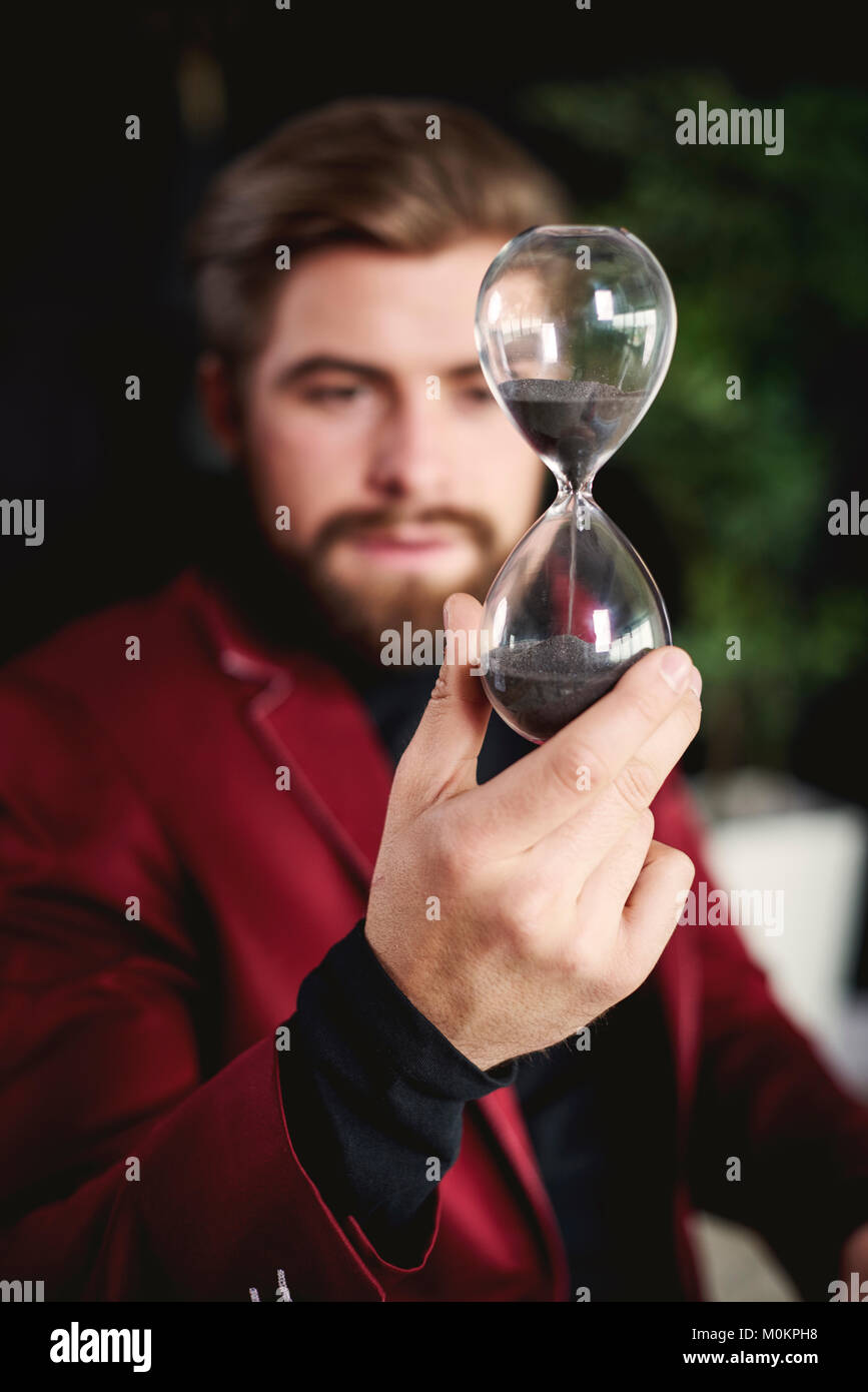 Business person holding a hourglass Stock Photo Alamy