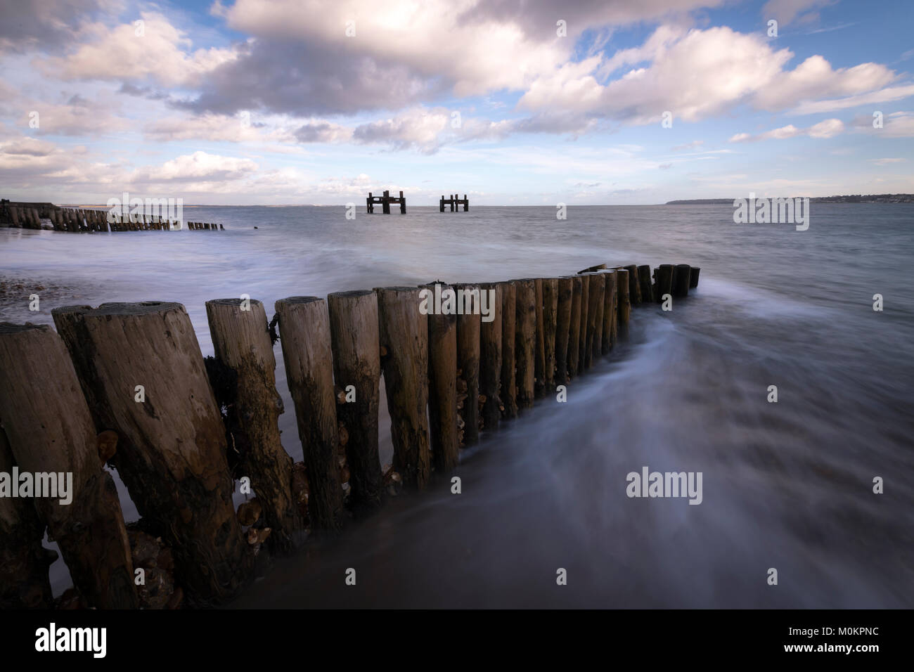The wooden groynes and dolphin structures at Lepe in Hampshire. Stock Photo