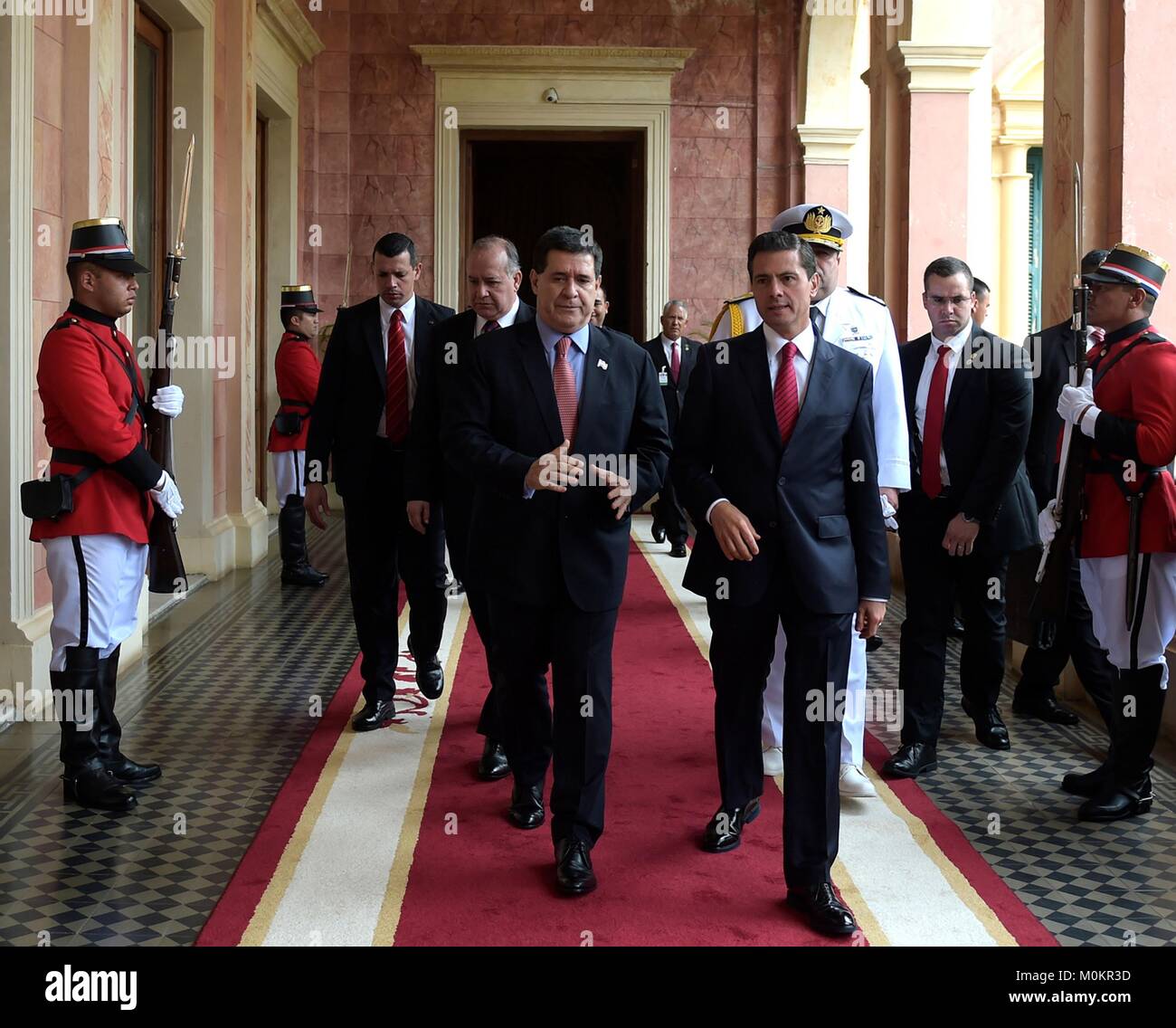 Mexican President Enrique Pena Nieto, right, walks with Paraguay President Horacio Cartes prior to signing bilateral agreements at the Palacio de López January 18, 2018 in Asuncion, Paraguay. Stock Photo