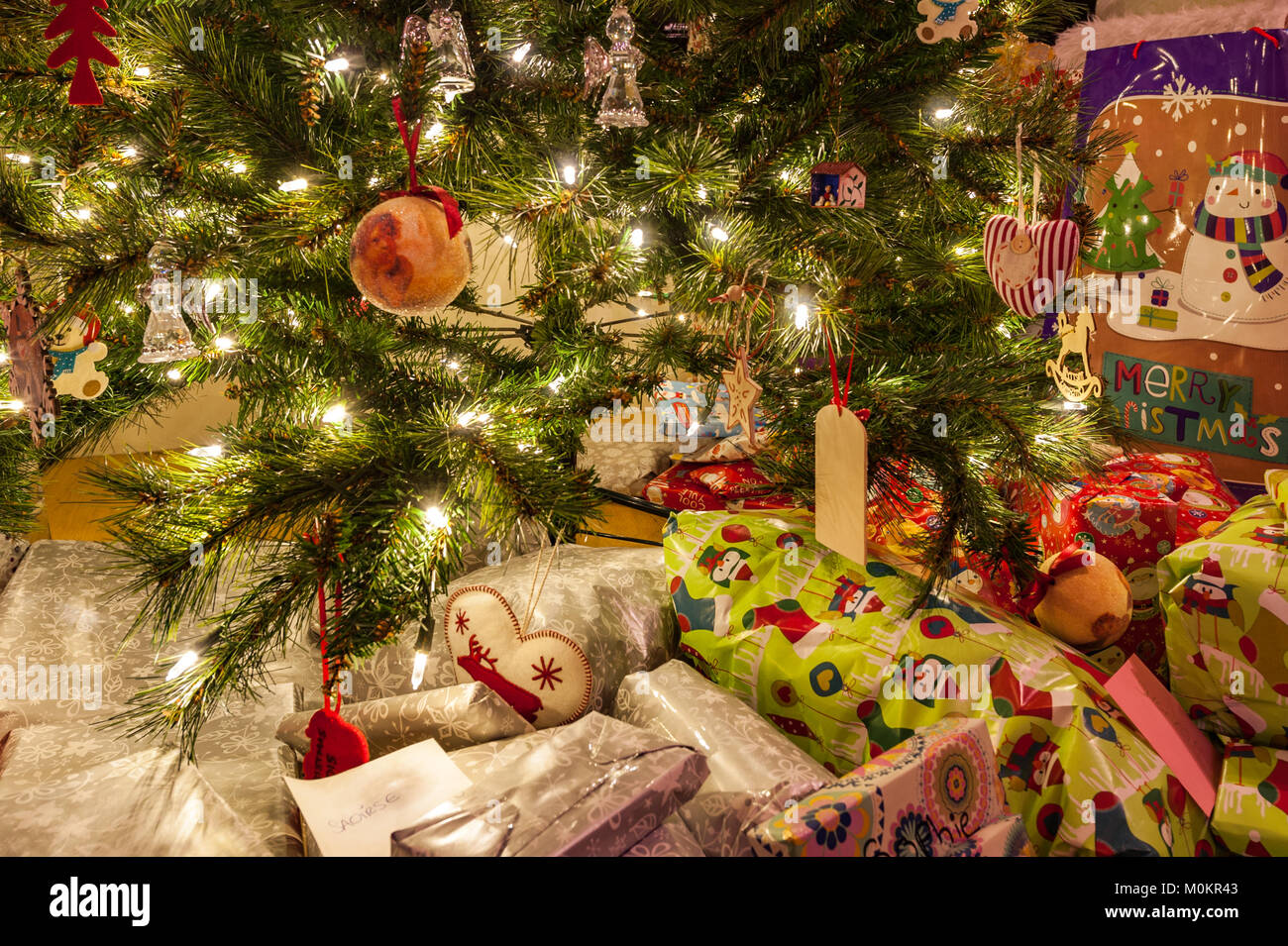 Christmas tree with decorations, lights and Christmas presents. Stock Photo