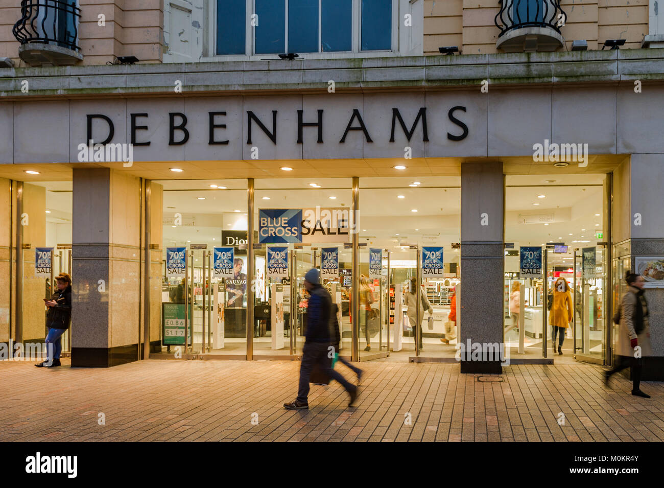 Debenhams Department Store on Patrick Street, Cork, Ireland with shoppers at dusk in the January sales. Stock Photo