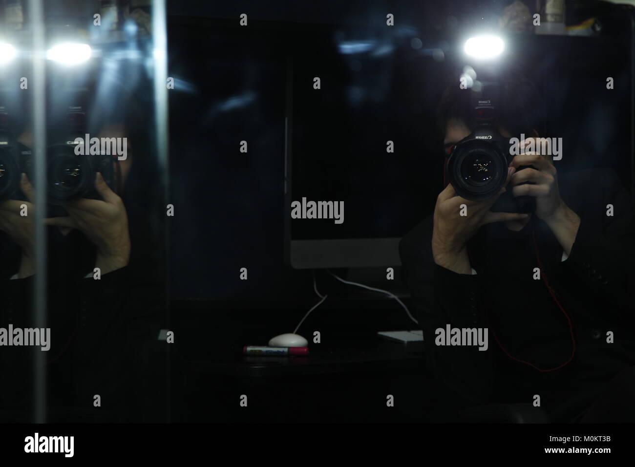 Dark reflection taking a photo of mirror with flash and canon eos 1d mkIV  Stock Photo - Alamy