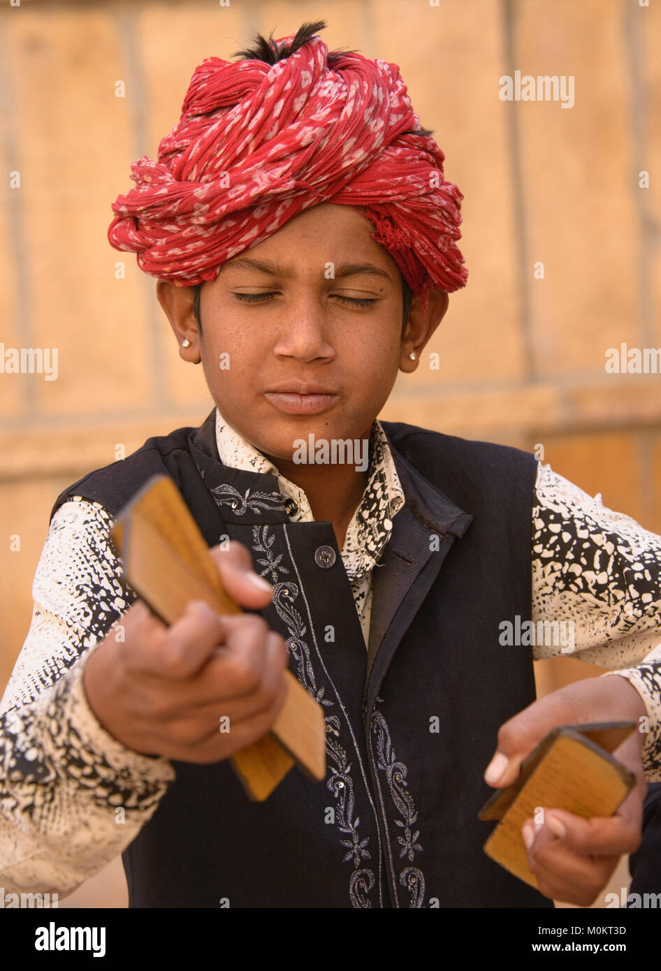 Child musicians busking outside of the Patwon Ji Ki Haveli, Jaisalmer, Rajasthan, India Stock Photo