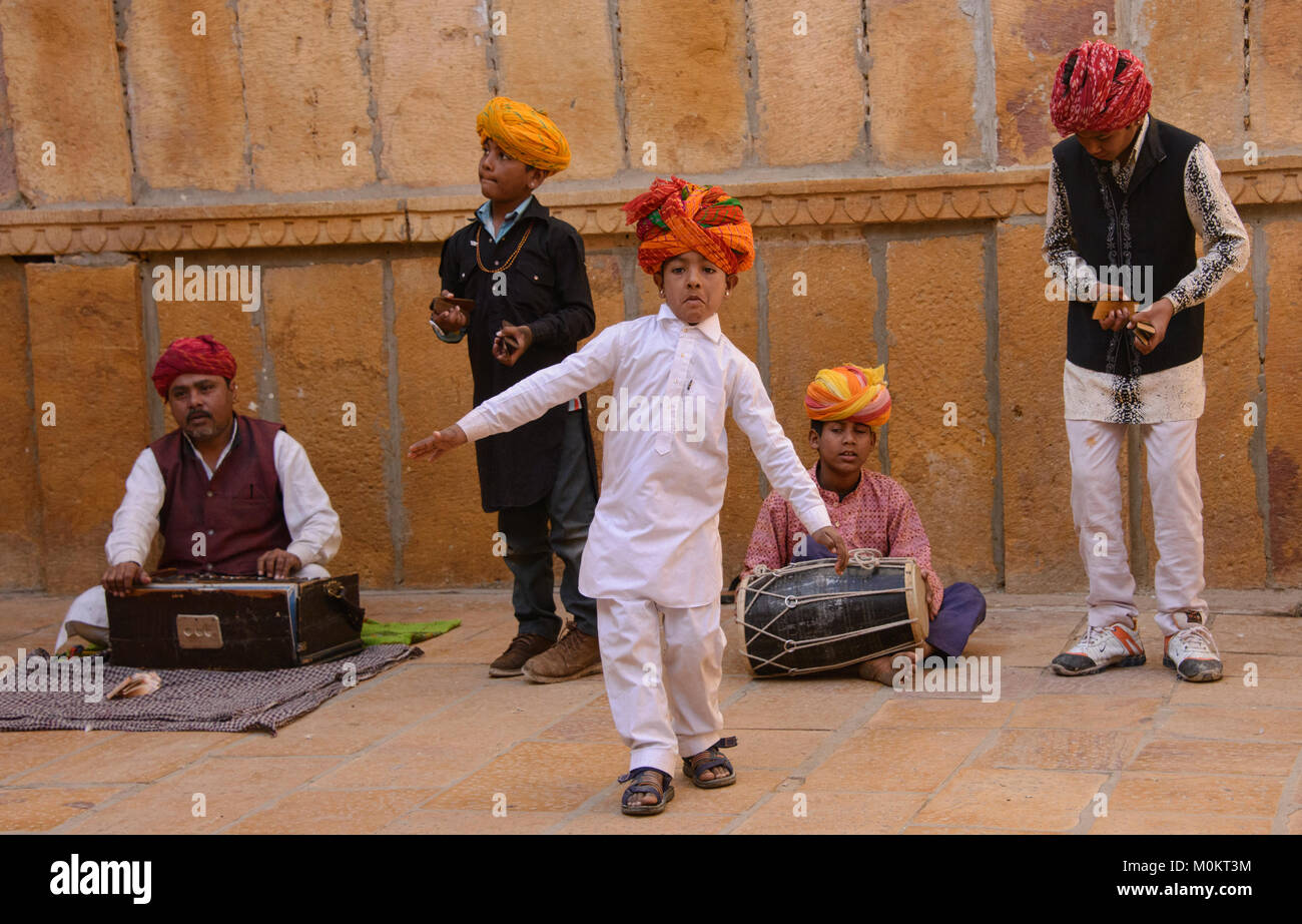 Child musicians busking outside of the Patwon Ji Ki Haveli, Jaisalmer, Rajasthan, India Stock Photo