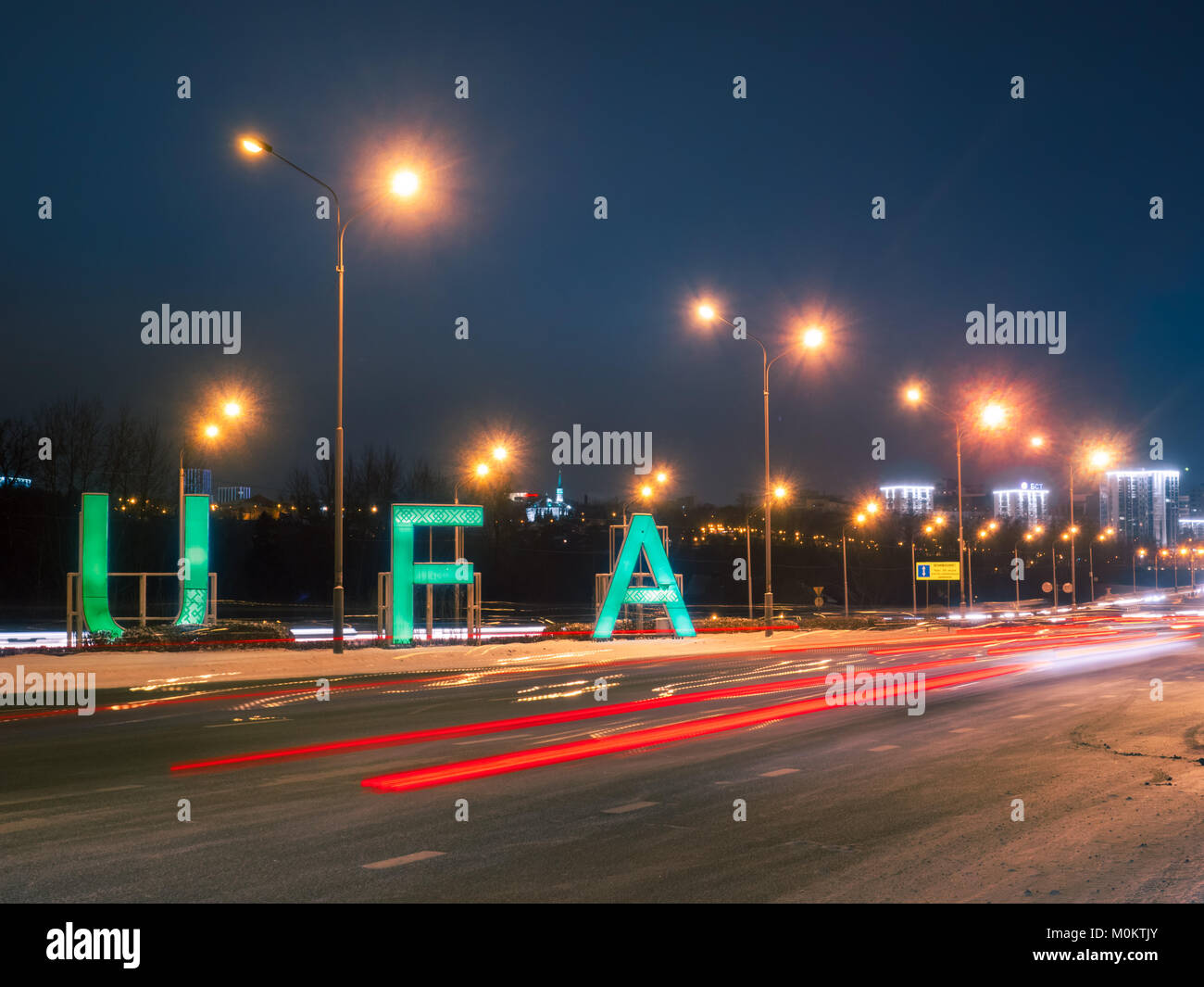sign Ufa and transport traffic on main road into city in the winter