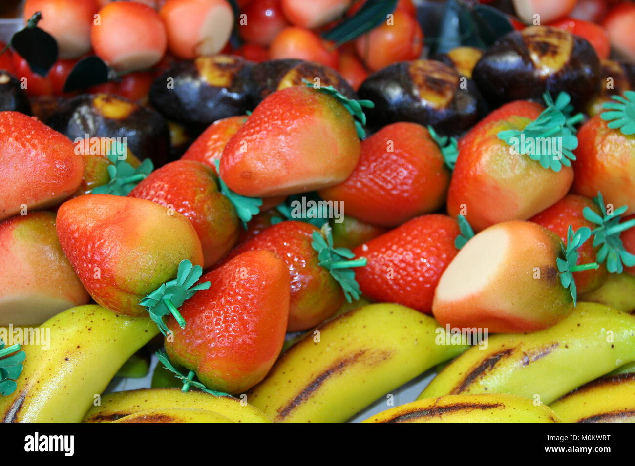 typical sicilian  marzipan pastries in shape of various colored  fruits also known as  frutta martorana. Stock Photo