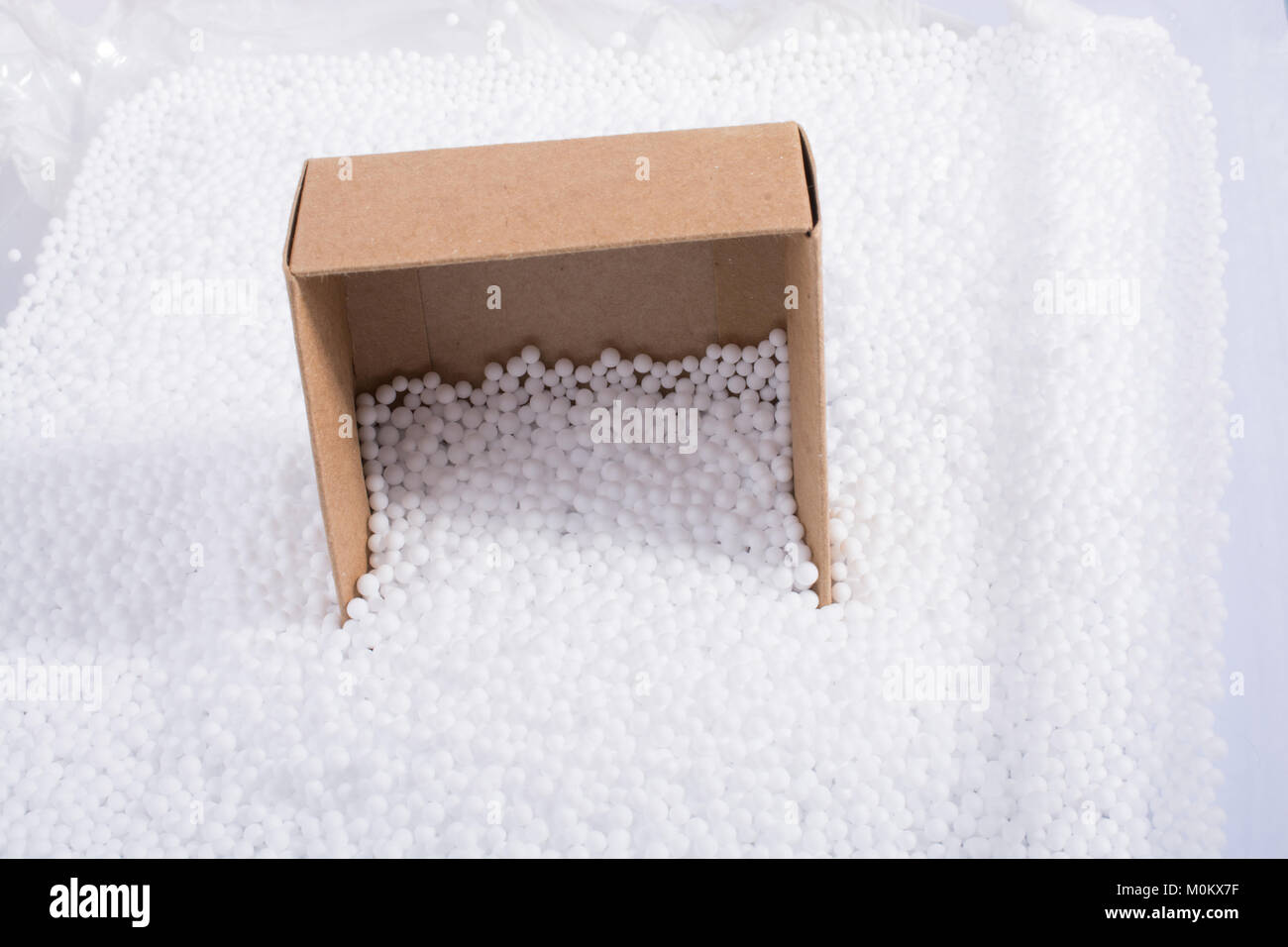 Box on little white polystyrene foam balls Stock Photo - Alamy