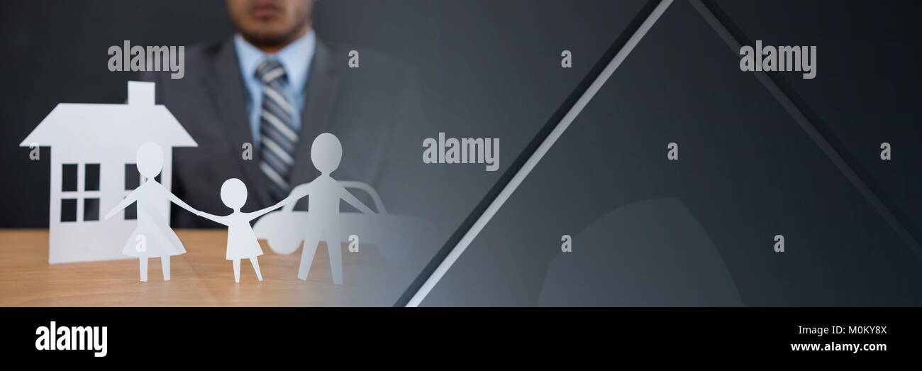 Paper Cut Out family home with businessman Stock Photo