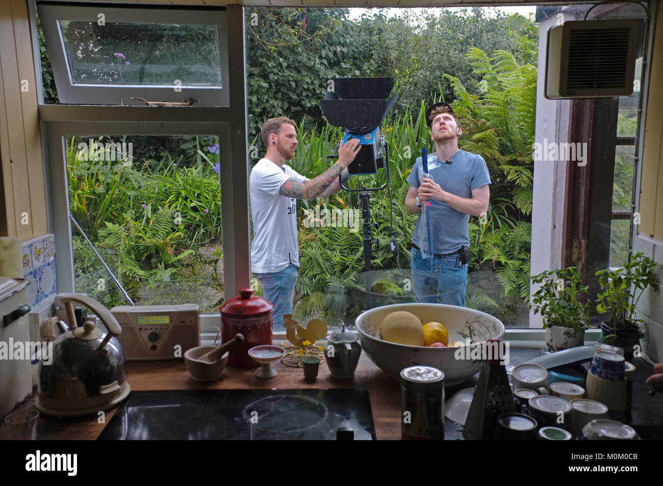 Lighting crew setting up for filming outside a domestic house. Stock Photo