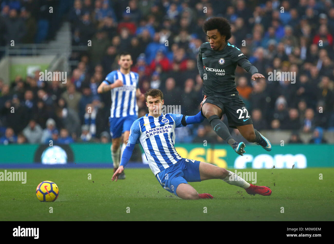 Willian of Chelsea evades a tackle from Solly March of Brighton during the Premier League match between Brighton and Hove Albion and Chelsea at the American Express Community Stadium in Brighton and Hove. 20 Jan 2018 Stock Photo