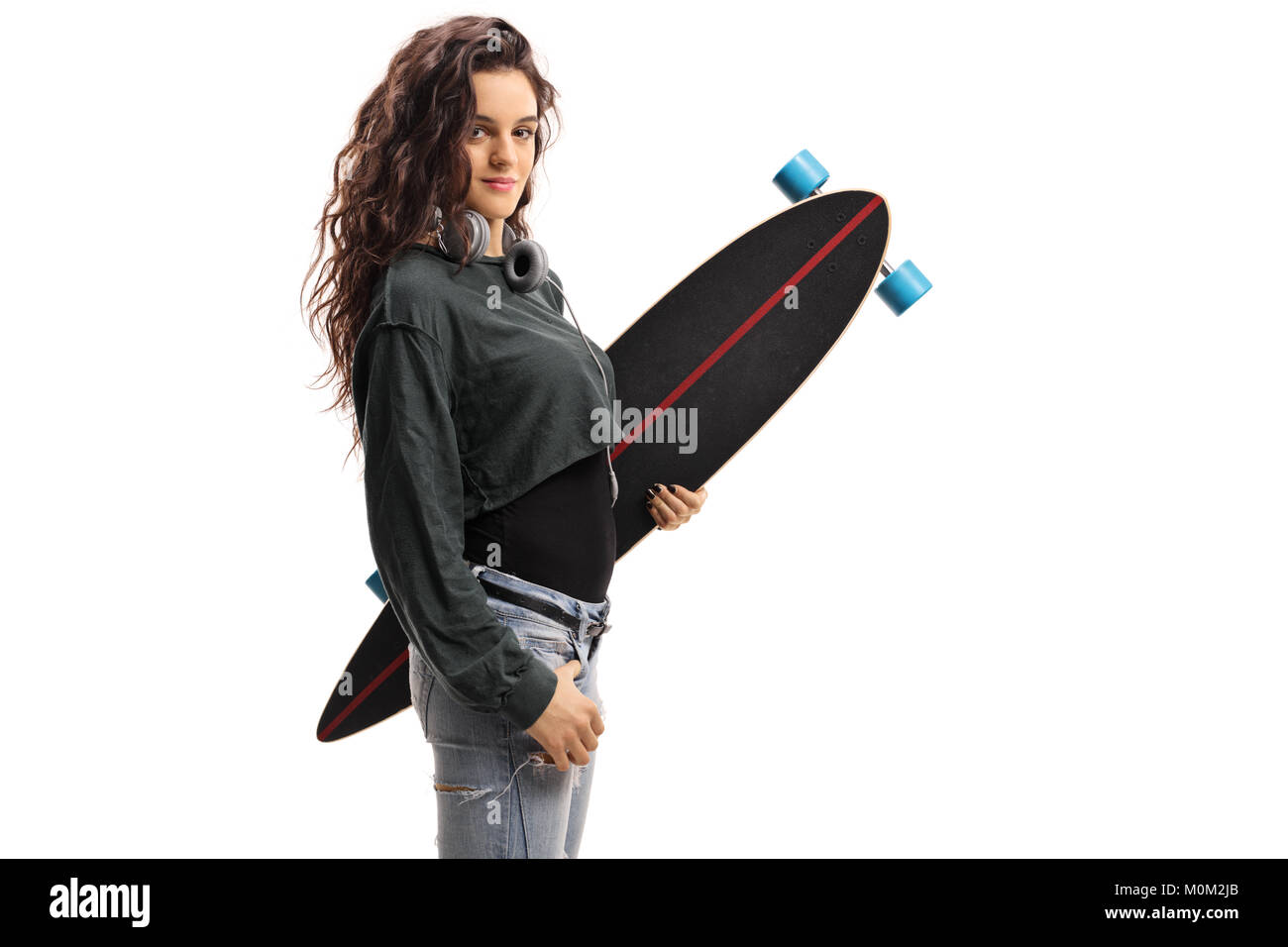 Teenage girl holding a longboard isolated on white background Stock Photo