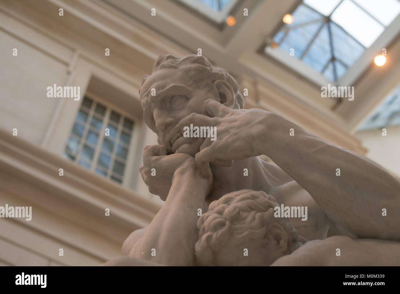 Low angle view of marble sculpture of a man gripping his face in pain, Metropolitan Museum of Art, New York City , New York Stock Photo