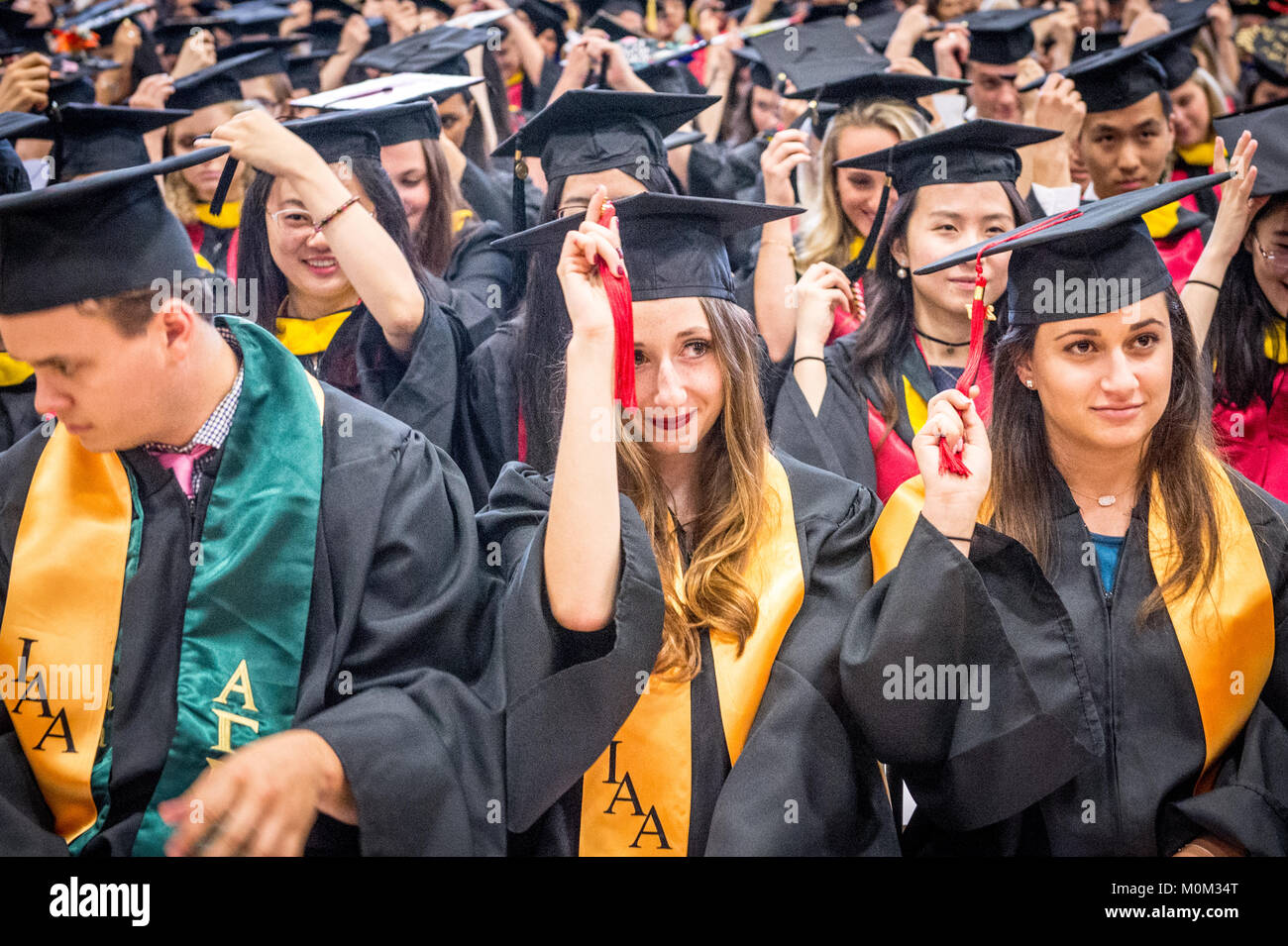 Group of young college graduates move their tassels on their graduation