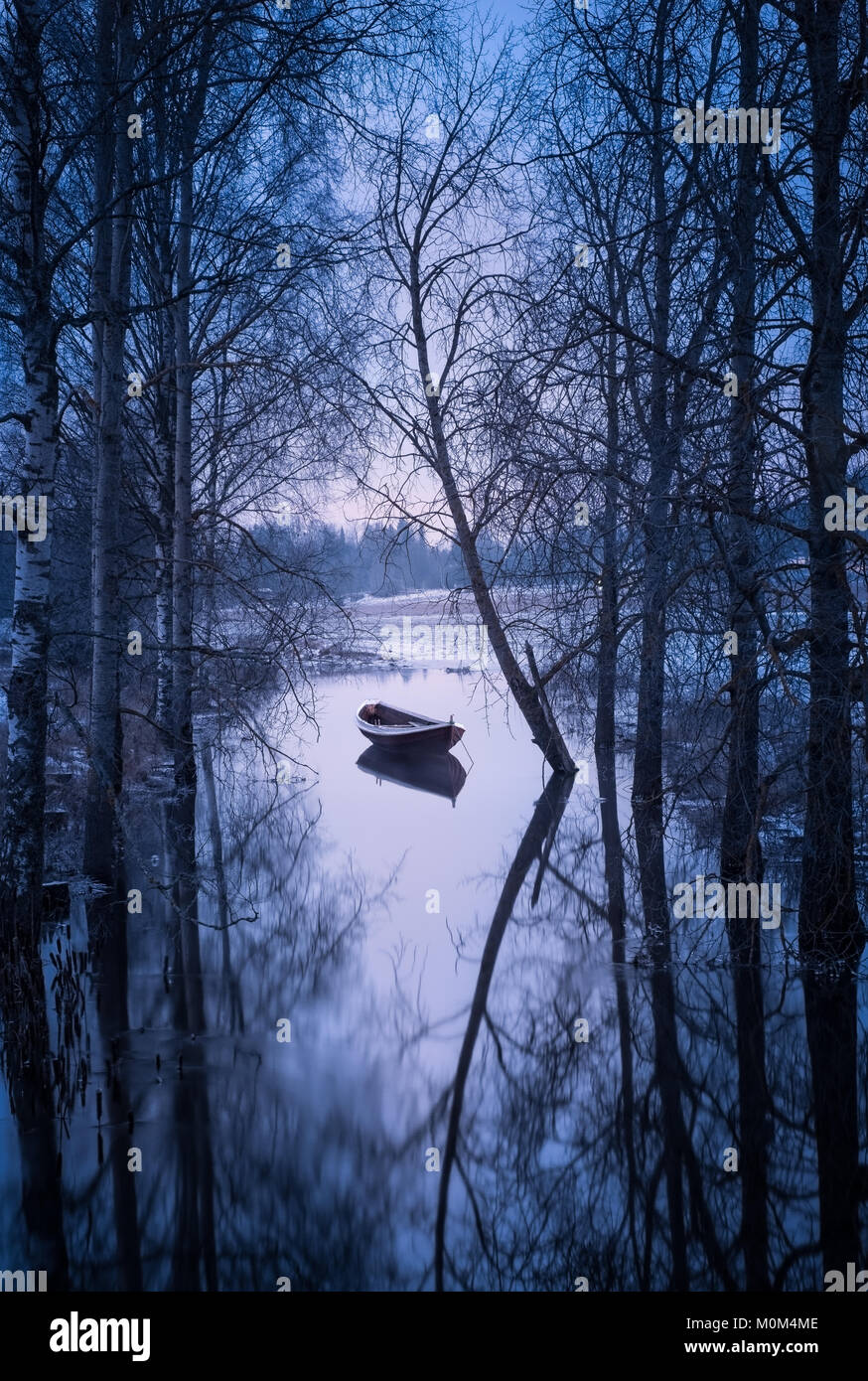 Winter landscape with sunset and boat at evening in Finland Stock Photo