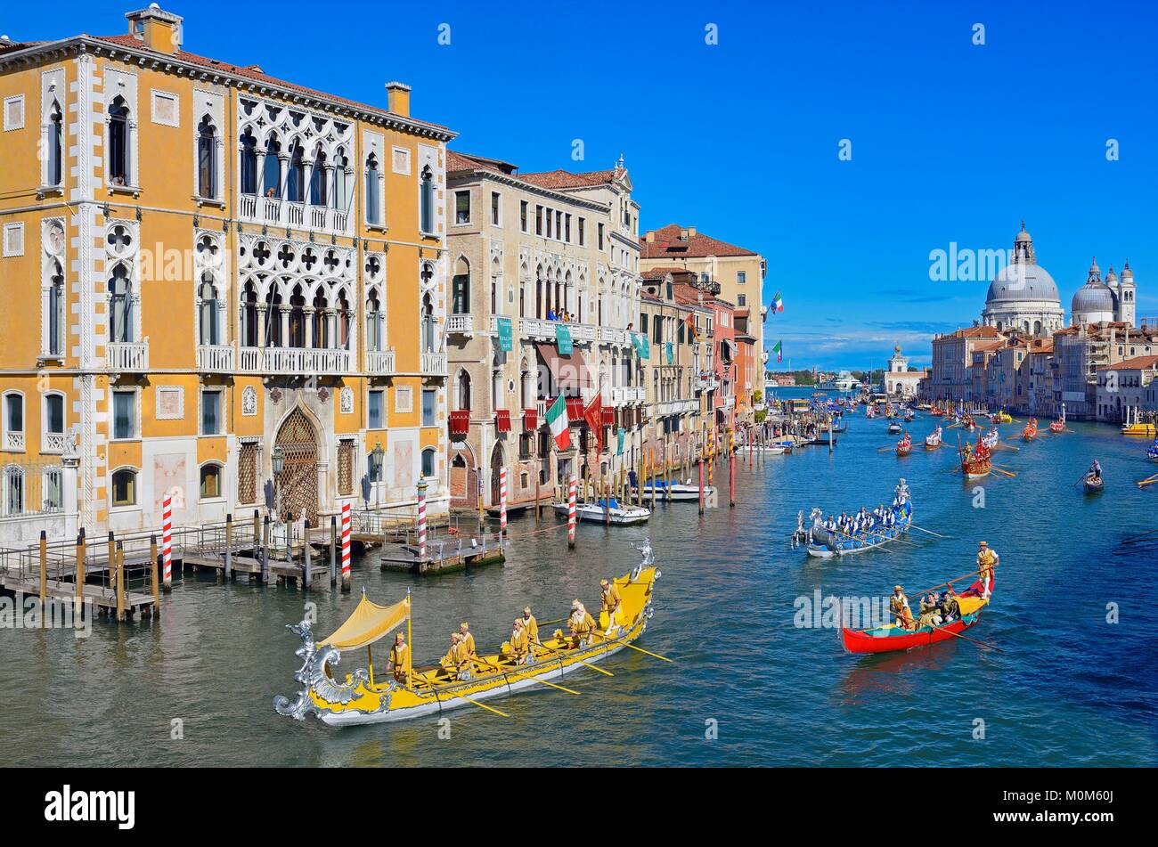 Italy,Veneto,Venice listed as World Heritage by UNESCO,the historical regatta on the Grand Canal,Cavalli Franchetti palace on the left and Santa Maria Della Salute church in the background Stock Photo