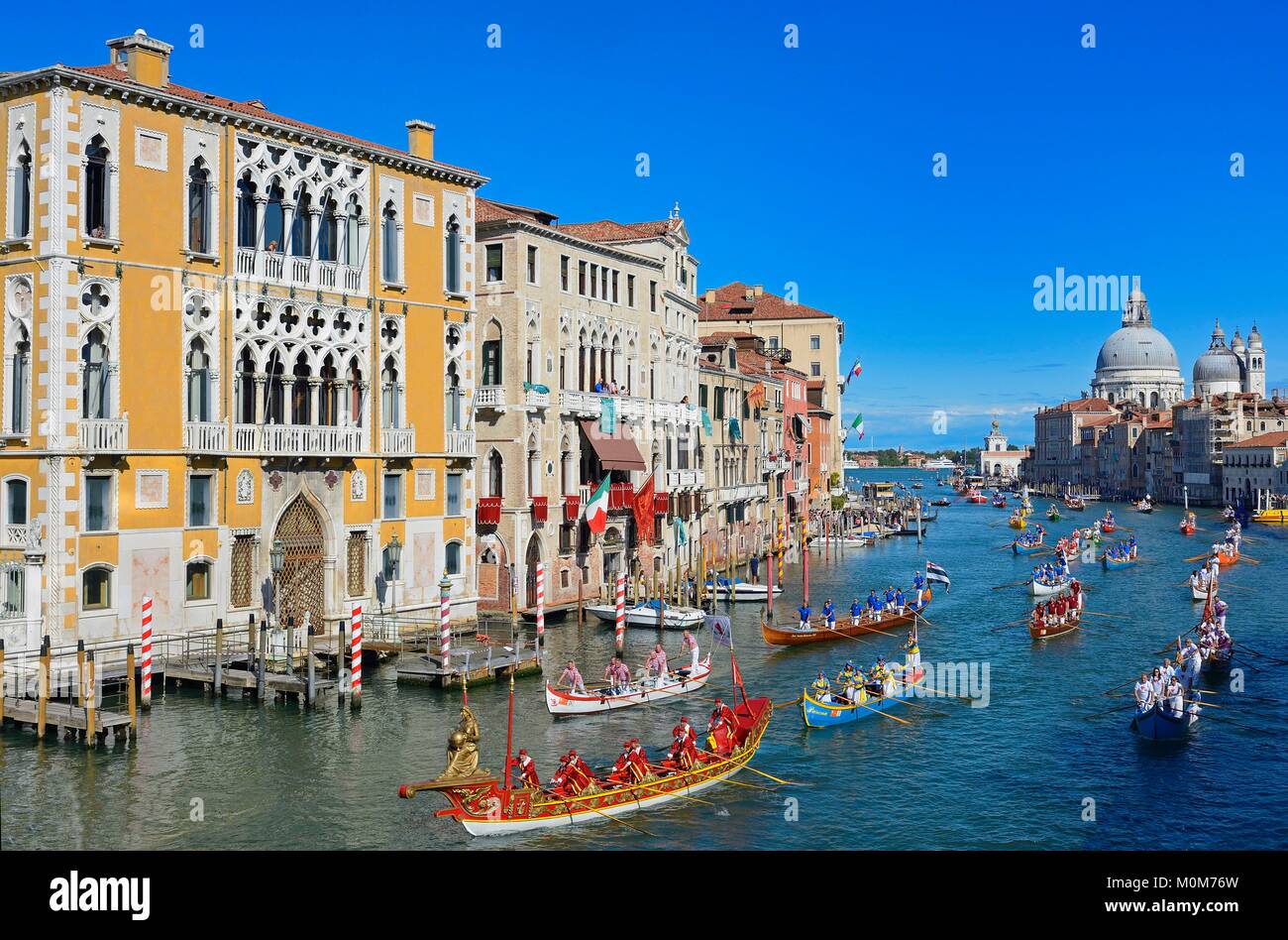 Italy,Veneto,Venice listed as World Heritage by UNESCO,the historical regatta on the Grand Canal,Cavalli Franchetti palace on the left and Santa Maria Della Salute church in the background Stock Photo