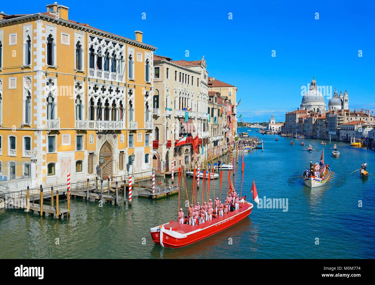 Italy,Veneto,Venice listed as World Heritage by UNESCO,the historical regatta on the Grand Canal with the Cavalli Franchetti palace on the left and Santa Maria Della Salute church in the background Stock Photo