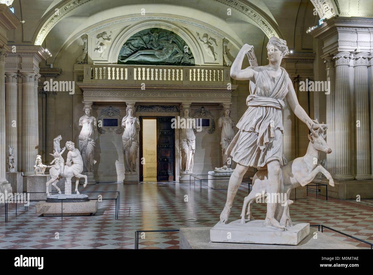 France,Paris,area listed as World Heritage by UNESCO,Louvre museum,Caryatids room,built between 1546 and 1549 by architect Pierre Lescot. Roman antiquities department,roman replicas of greek sculptures. in the foreground: Diana of Versailles (Ist or II nd century A.D.) Stock Photo