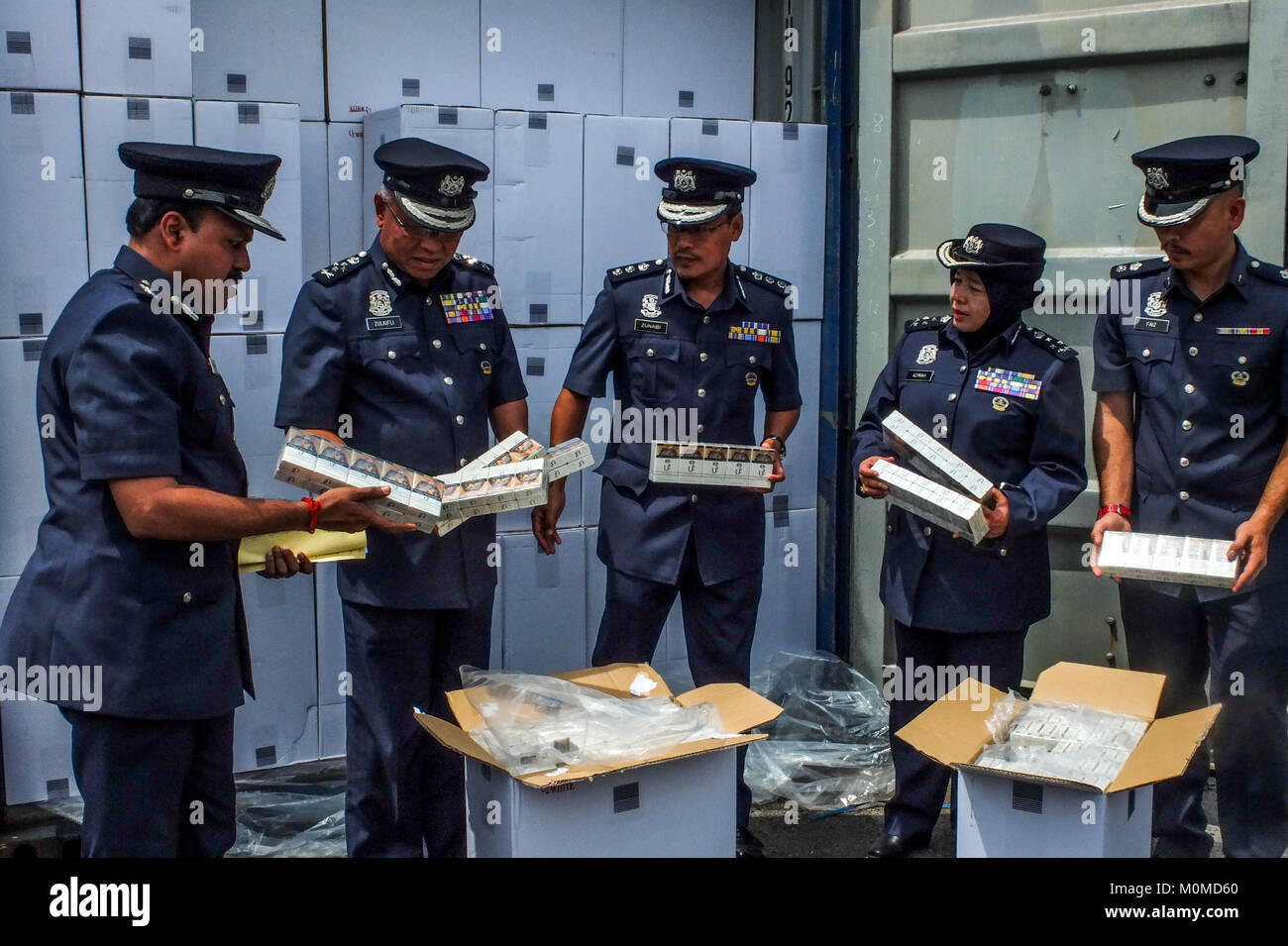 SEPANG, MALAYSIA JANUARY 23 Malaysian customs hold a illegal cigarettes boxs near the seized