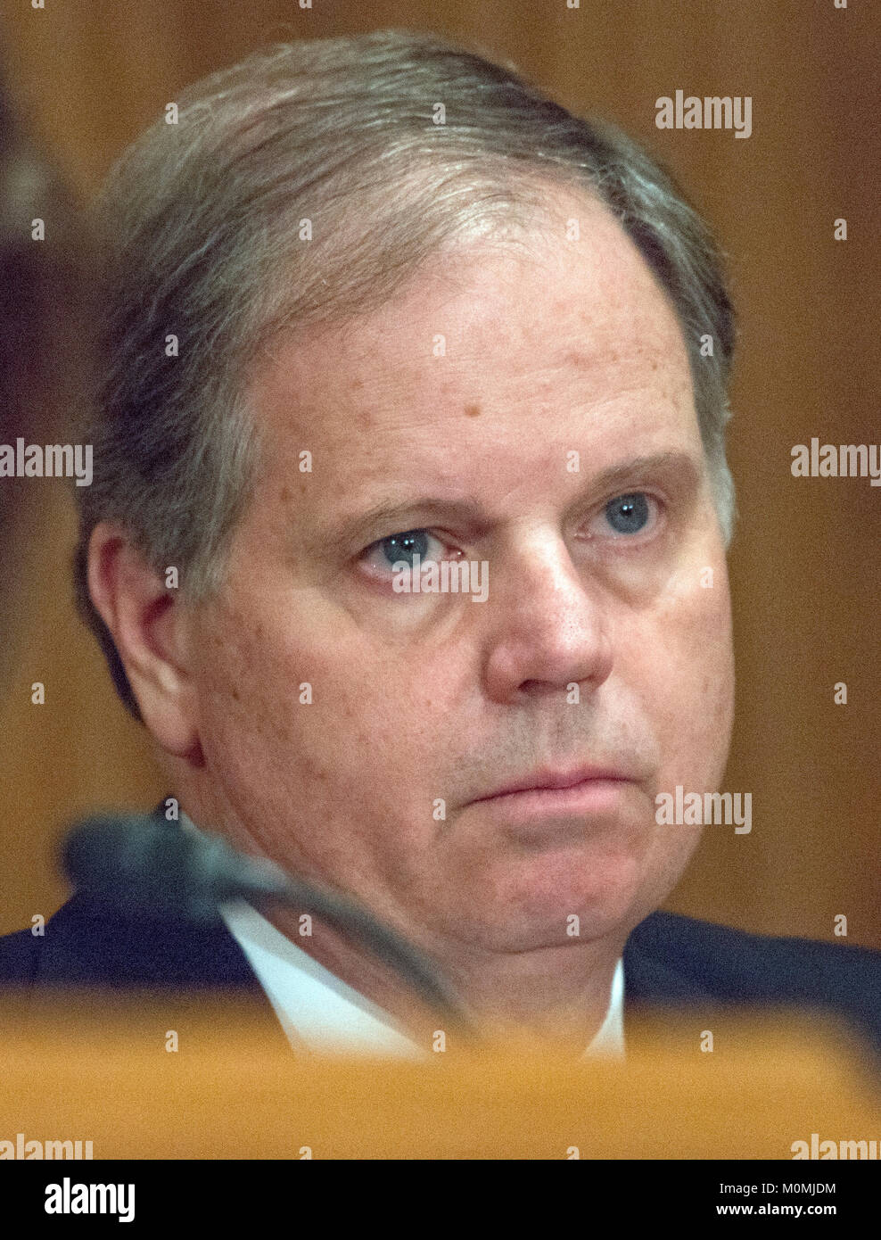 United States Senator Doug Jones (Democrat of Alabama) listens during