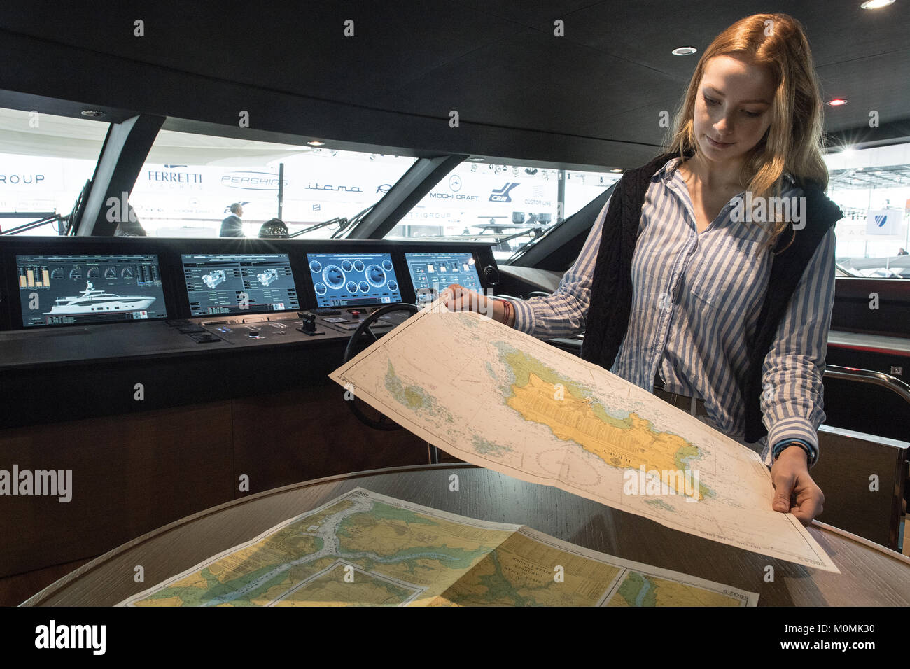 Duesseldorf, Germany. 19th Jan, 2018. The model Rebecca studying a sea map on the bridge of the Princess 35M motor yacht during the novelty tour of the water sports exhibition 'boot' (lit. 'boat') 2018 in Duesseldorf, Germany, 19 January 2018. More than 1800 exhibitors from more than 60 countries are showing novelties from the world of water sports from 20 to 28 January 2018. Credit: Federico Gambarini/dpa/Alamy Live News Stock Photo