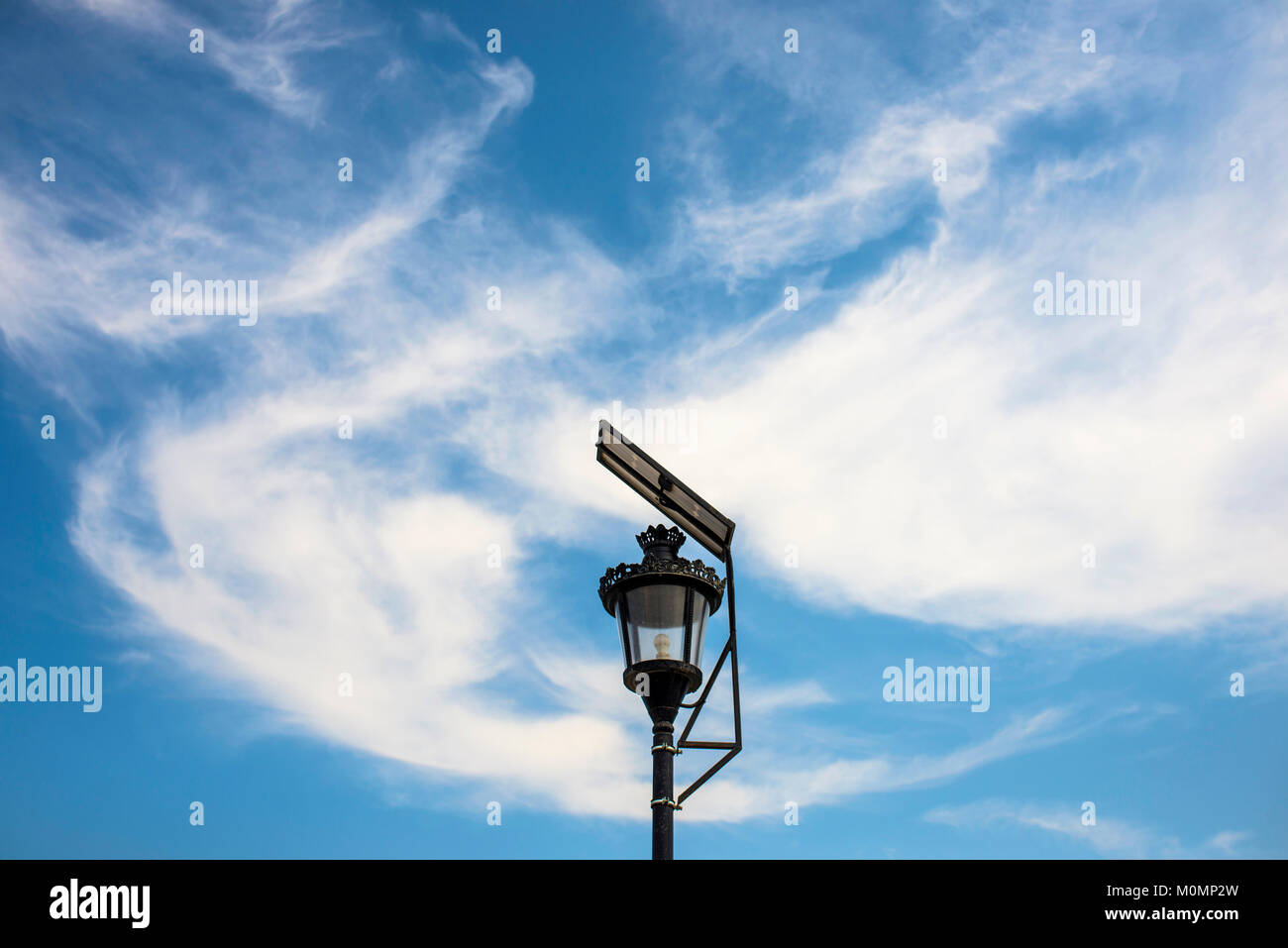 Solar panels for collecting sun energy on street candelabres Stock Photo