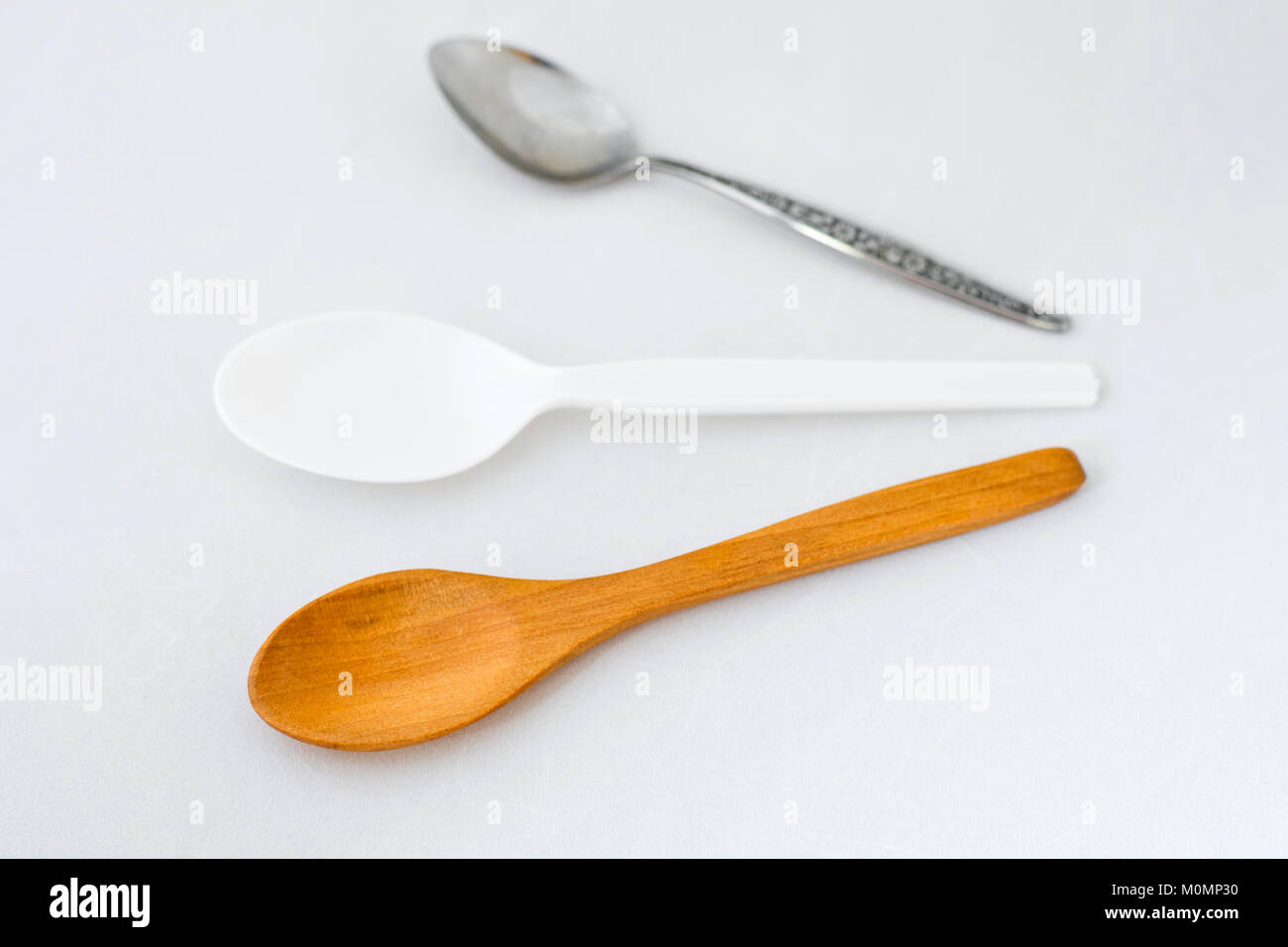 Wooden spoon, plastic spoon and metal spoon Stock Photo Alamy
