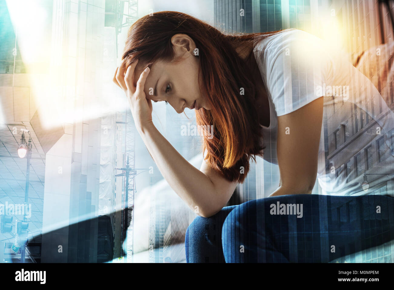 Pretty Disappointed Pretty disappointed woman sitting and bowing Stock Photo - Alamy