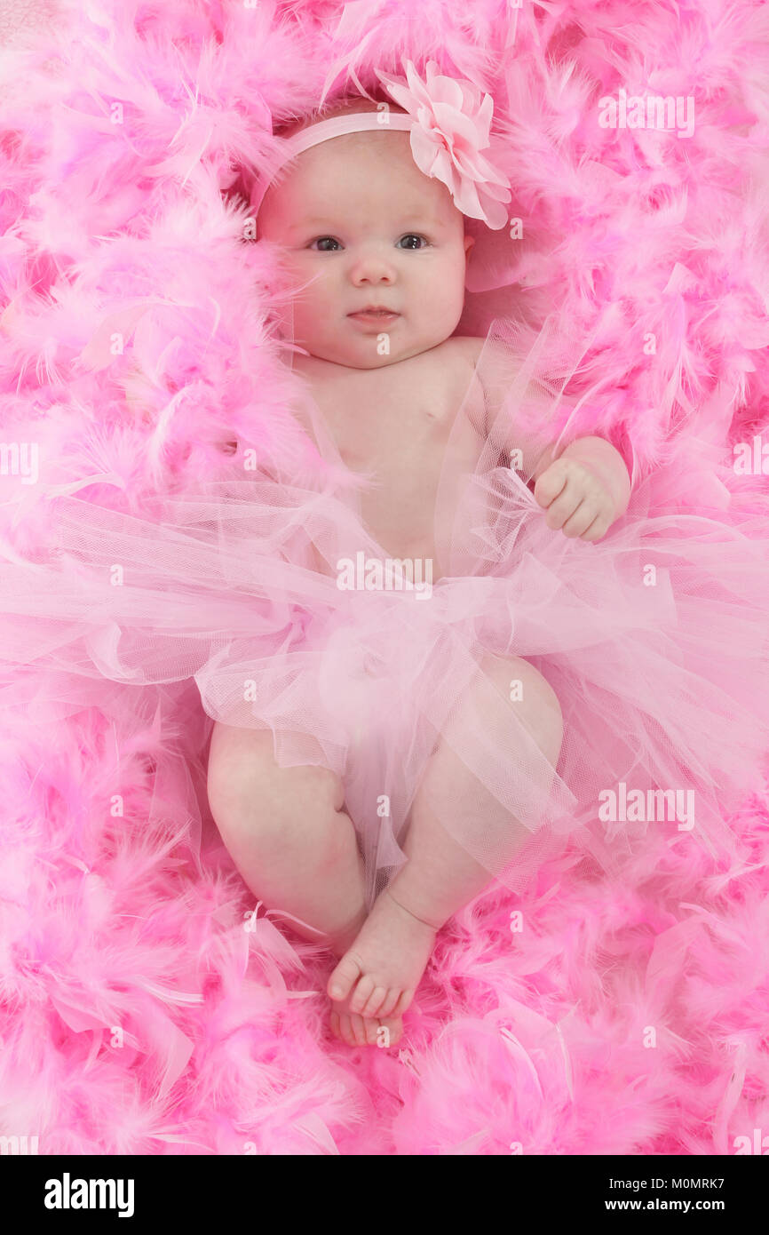 Infant on soft feather bed, baby girl Stock Photo Alamy