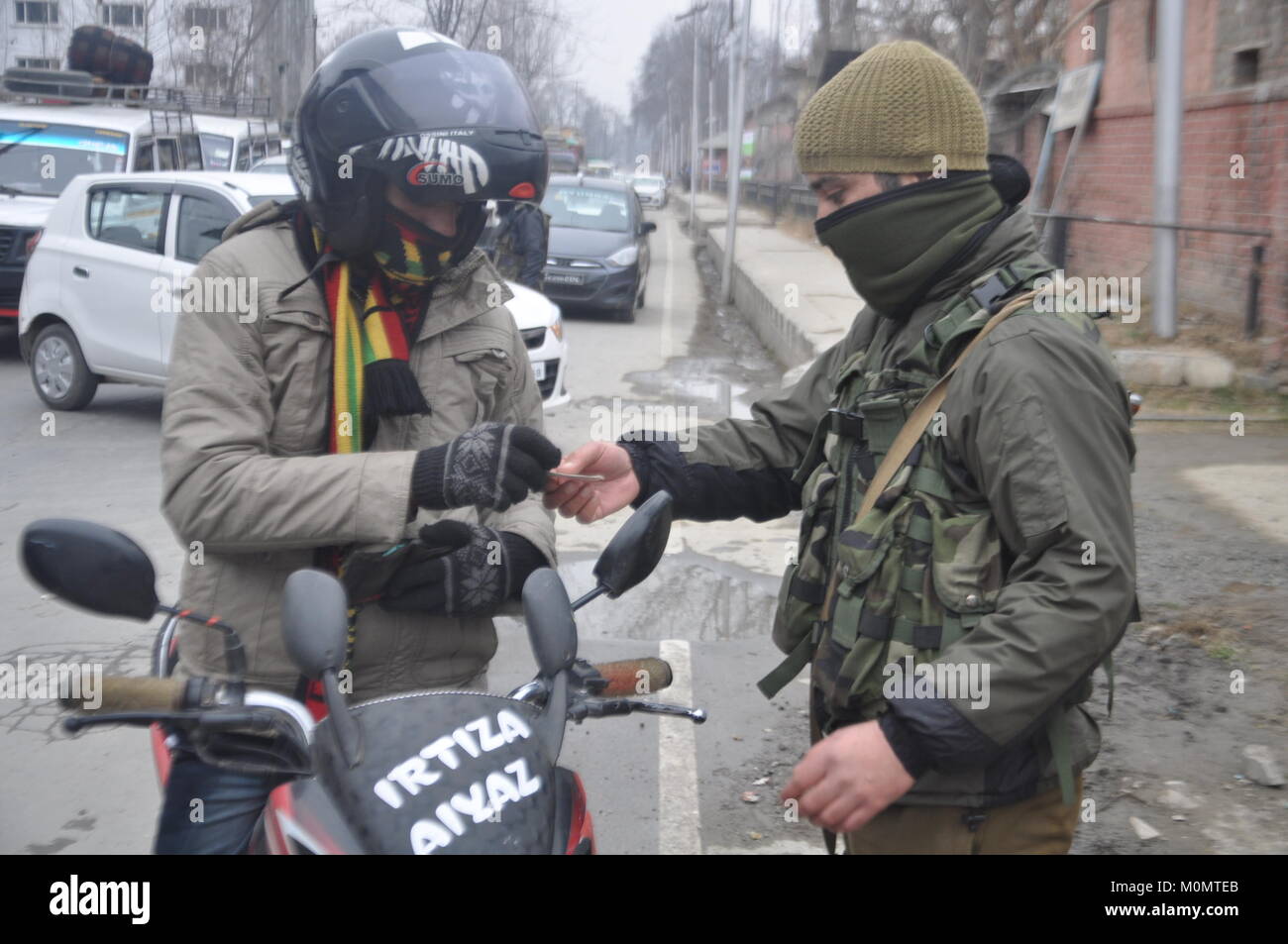Police Man Checking The Identity Of A Man in Anantnag, Kashmir on January 23, 2018, ahead of Indian Republic Day on January 26. Stock Photo