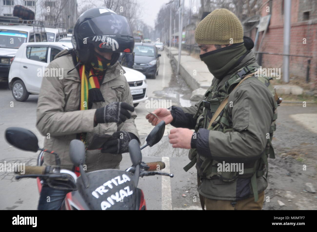 Police Man Checking The Identity Of A Man in Anantnag, Kashmir on January 23, 2018, ahead of Indian Republic Day on January 26. Stock Photo