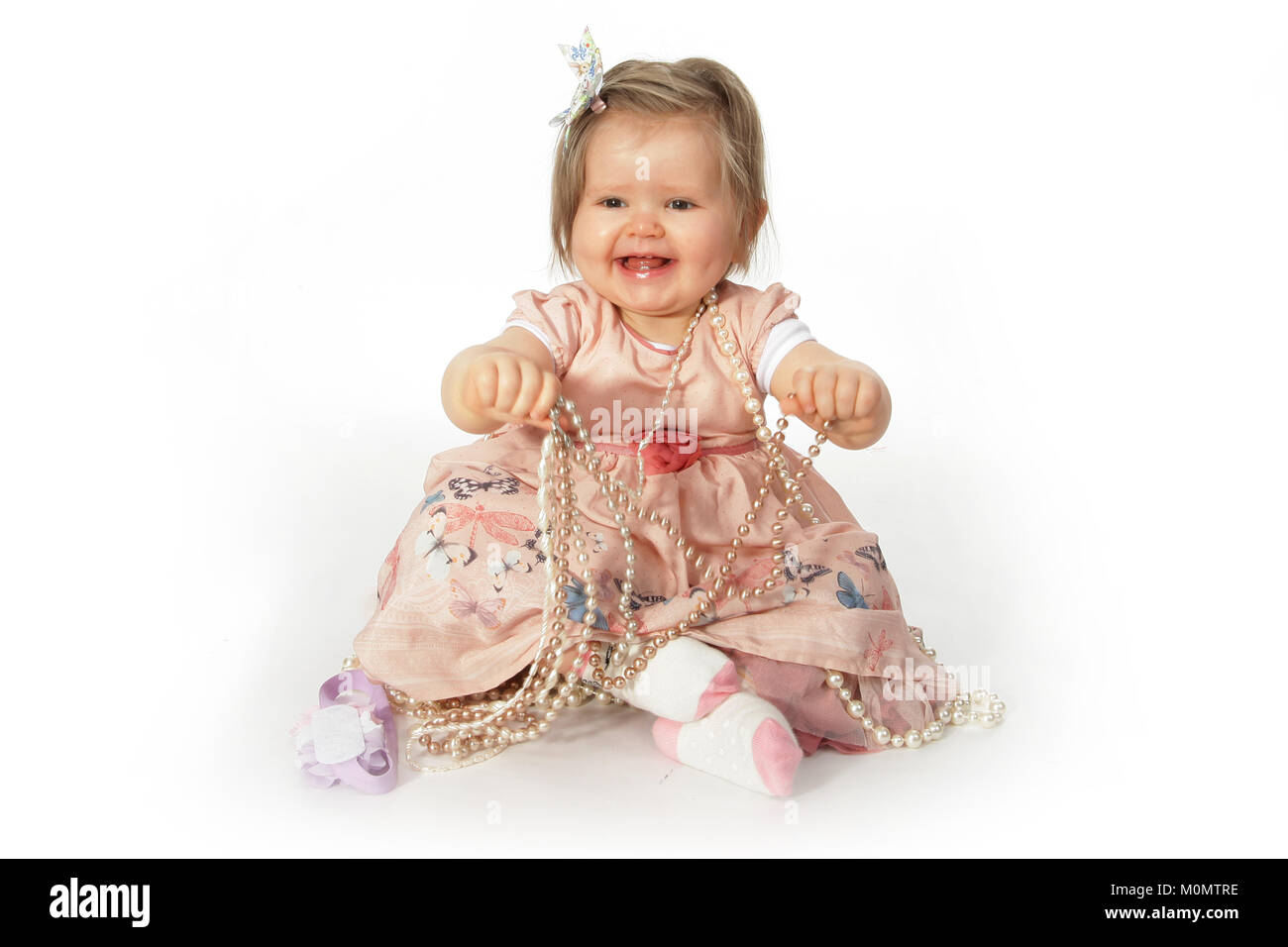 1 year old beautiful girl in pretty dress, child development, personal and social skills Stock Photo