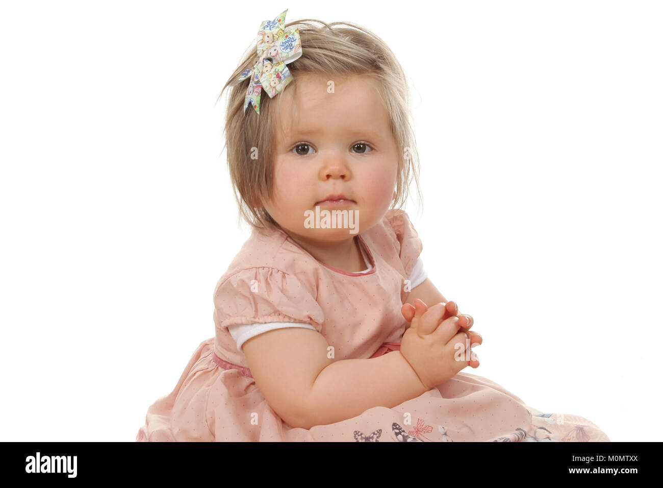 1 year old beautiful girl in pretty dress, child development, personal and social skills Stock Photo