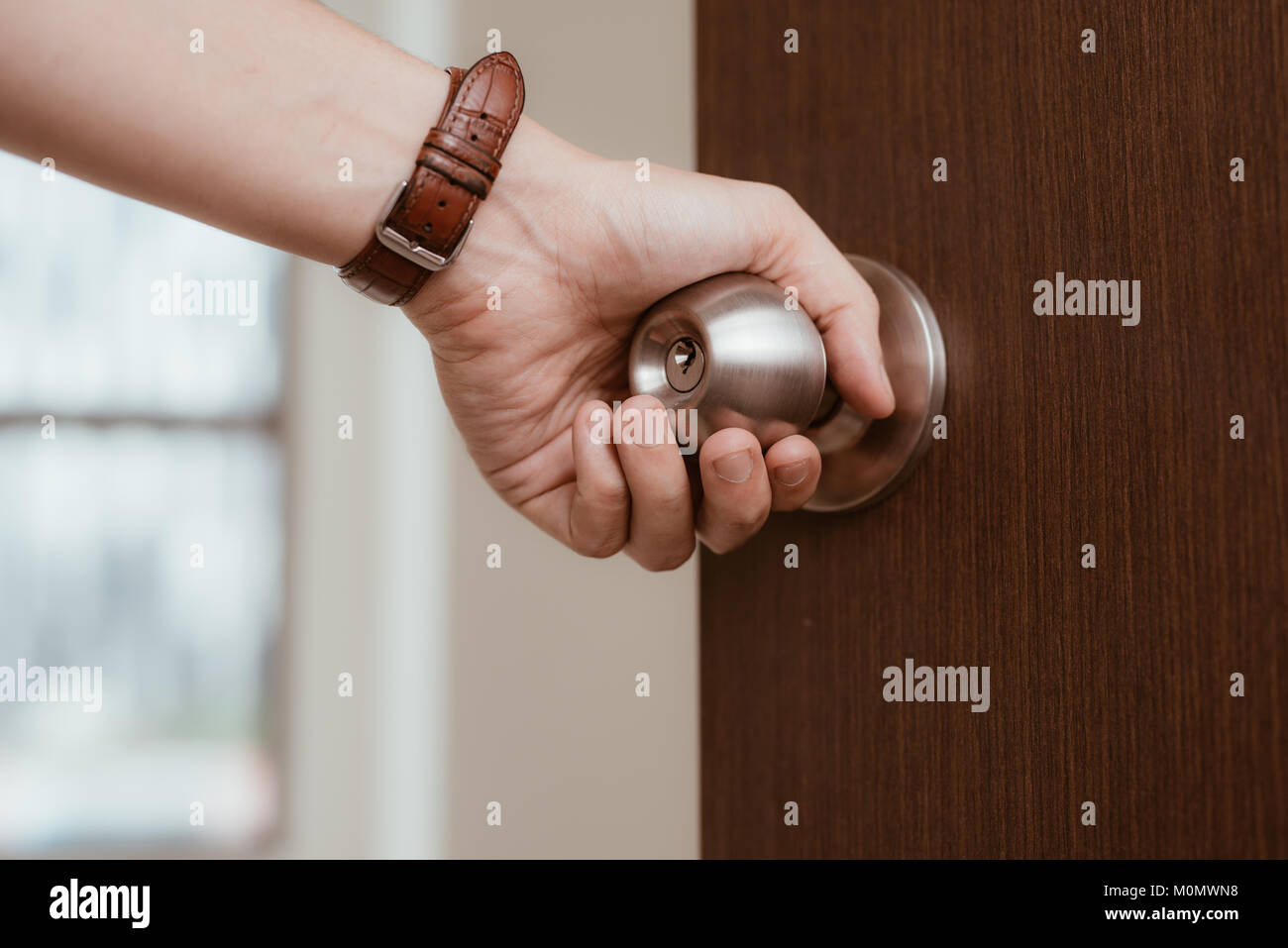 Male Hand Open Door Knob Or Opening The Door Stock Photo