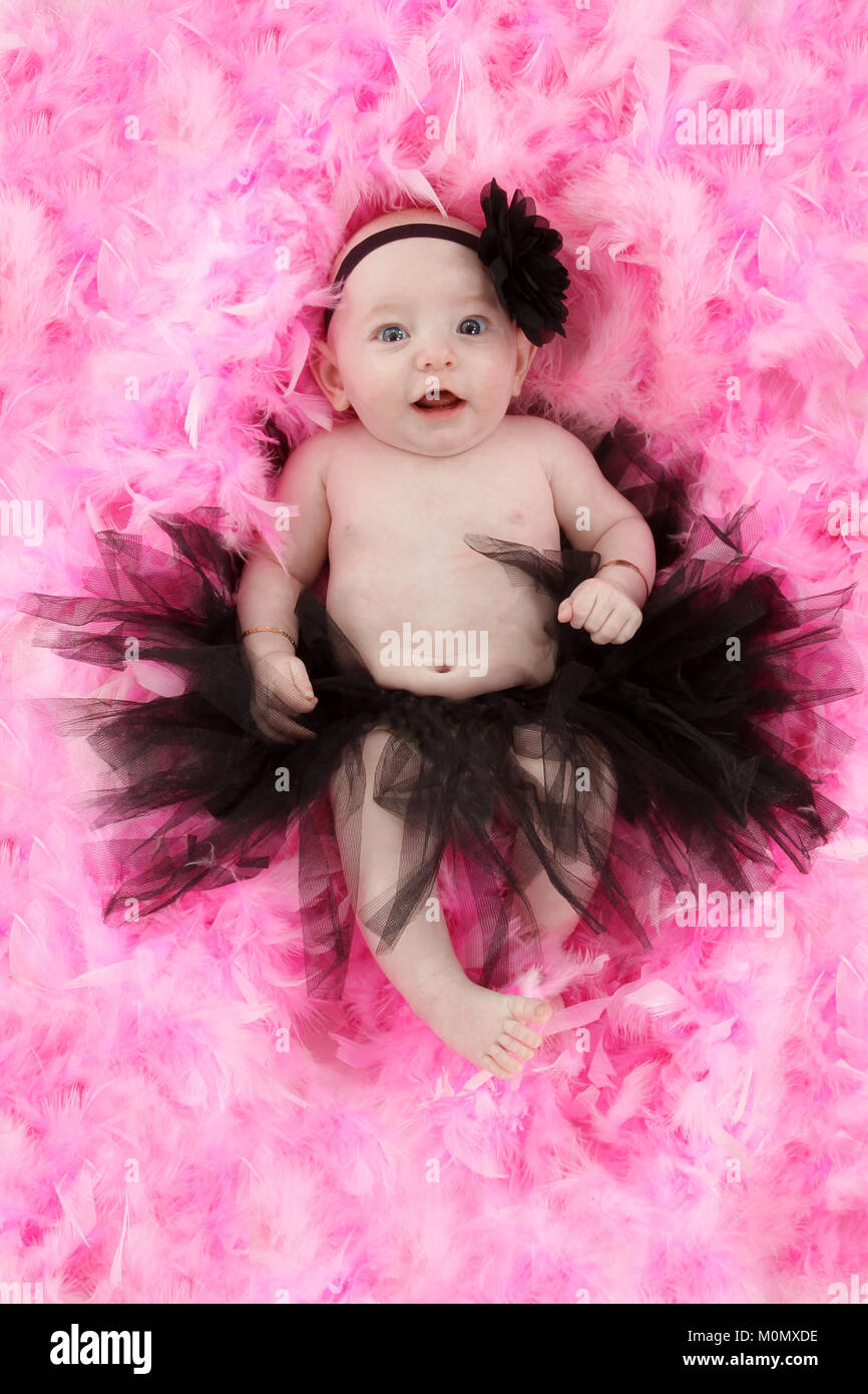 pretty litter girl, 4 month old baby girl in tutu on pink feathers