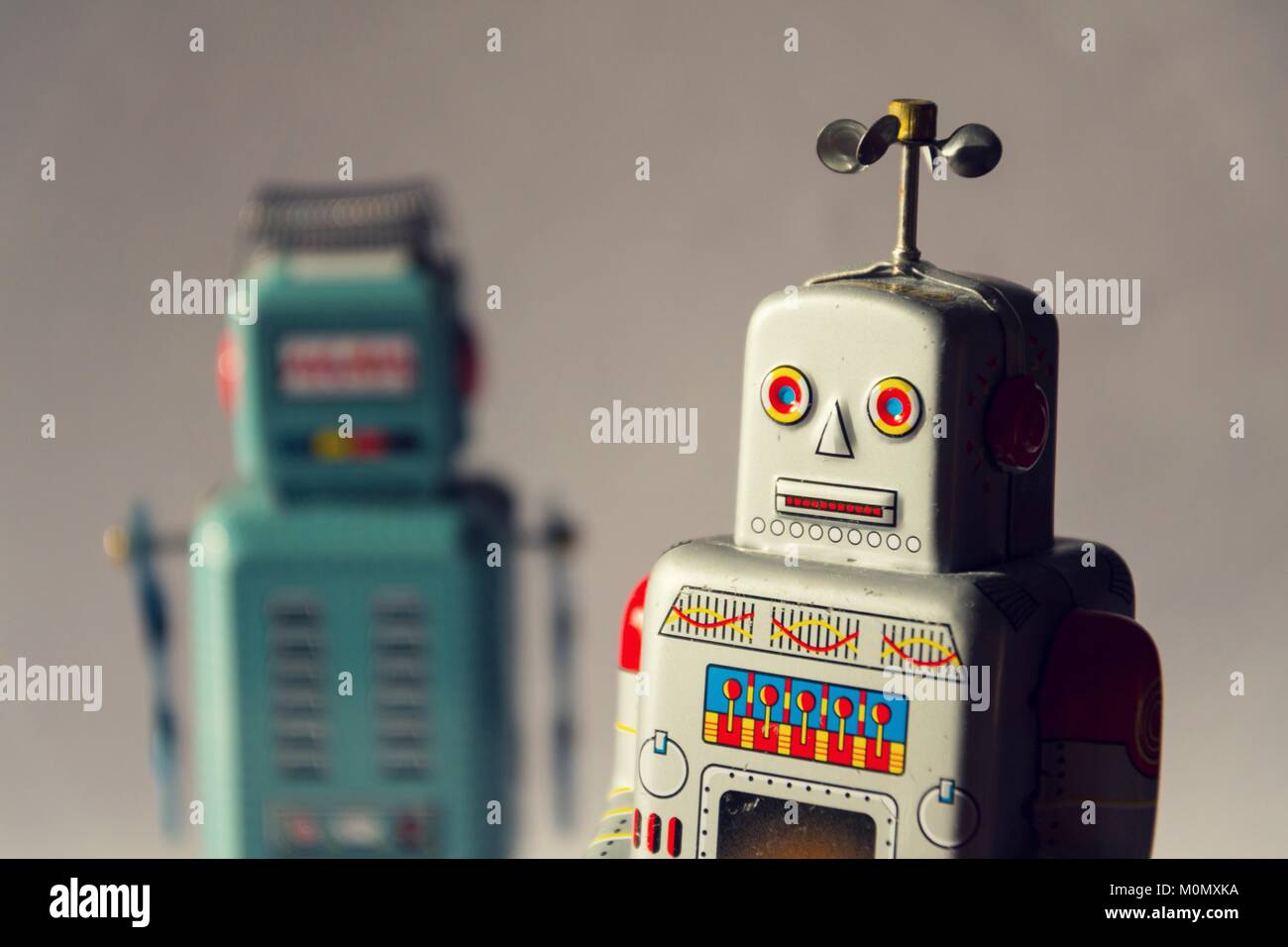 Two vintage tin toy robots, robotic delivery, artificial intelligence concept Stock Photo
