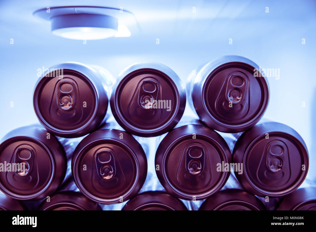 Cold soda drinks metal cans in fridge at night Stock Photo Alamy