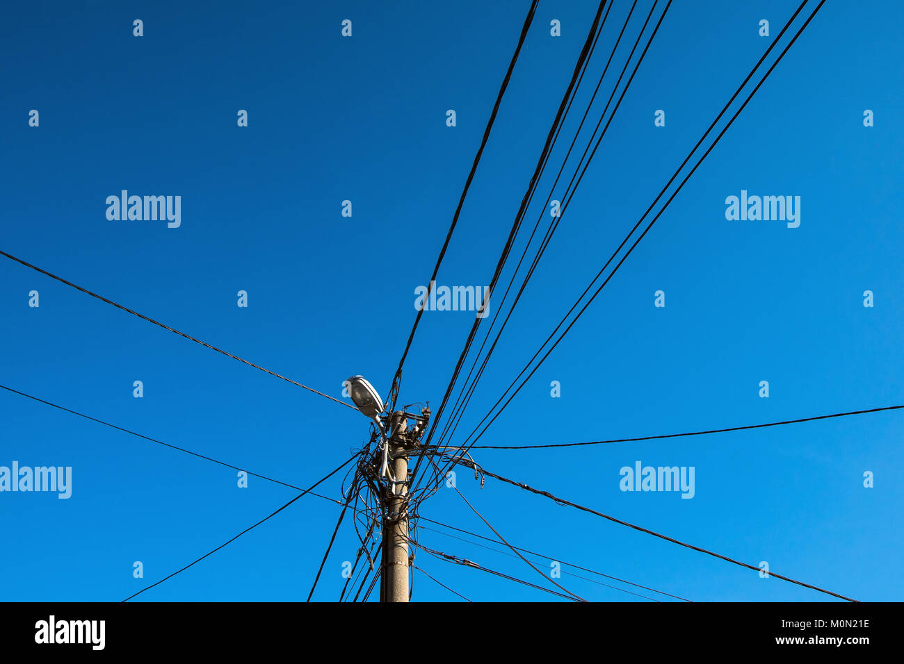Electricity pole for street light with messy wires Stock Photo