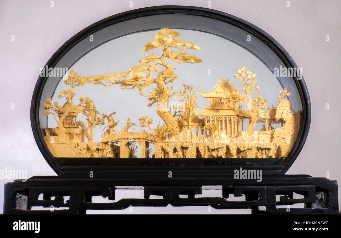 Hand crafted Chinese diorama of cork pagodas, bridge and trees scene / landscape, in an oval wooden case painted in black lacquer, with glass facings. Stock Photo