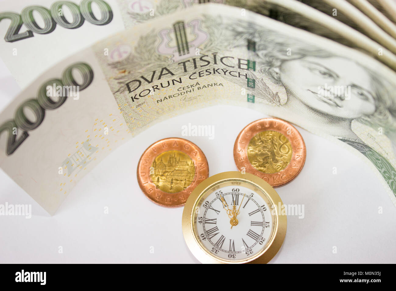 Czech banknotes like background, coins and watch that have five to twelve time. Highest time for action. Stock Photo