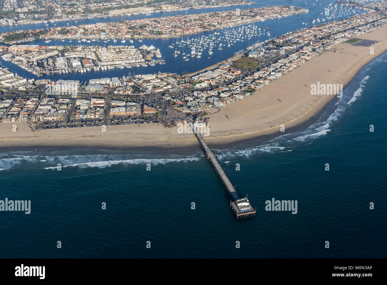 Aerial view of Newport Beach pier, homes, beach and harbor in Orange County, California. Stock Photo