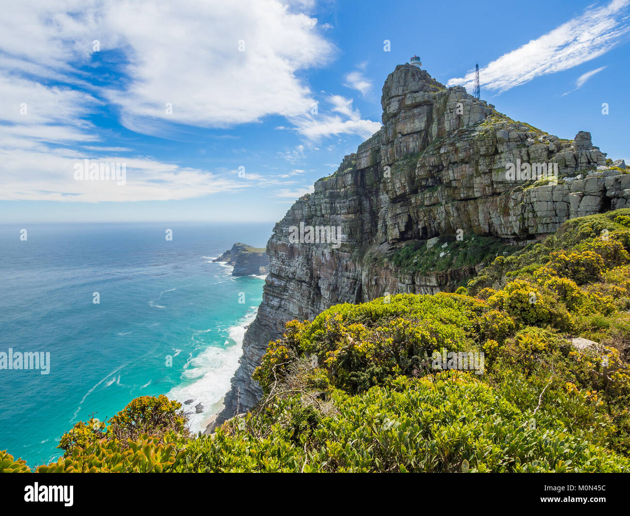 Scenic view on Cape Point with lighthouse, ocean and dramatic sky, Cape Town, South Africa Stock Photo