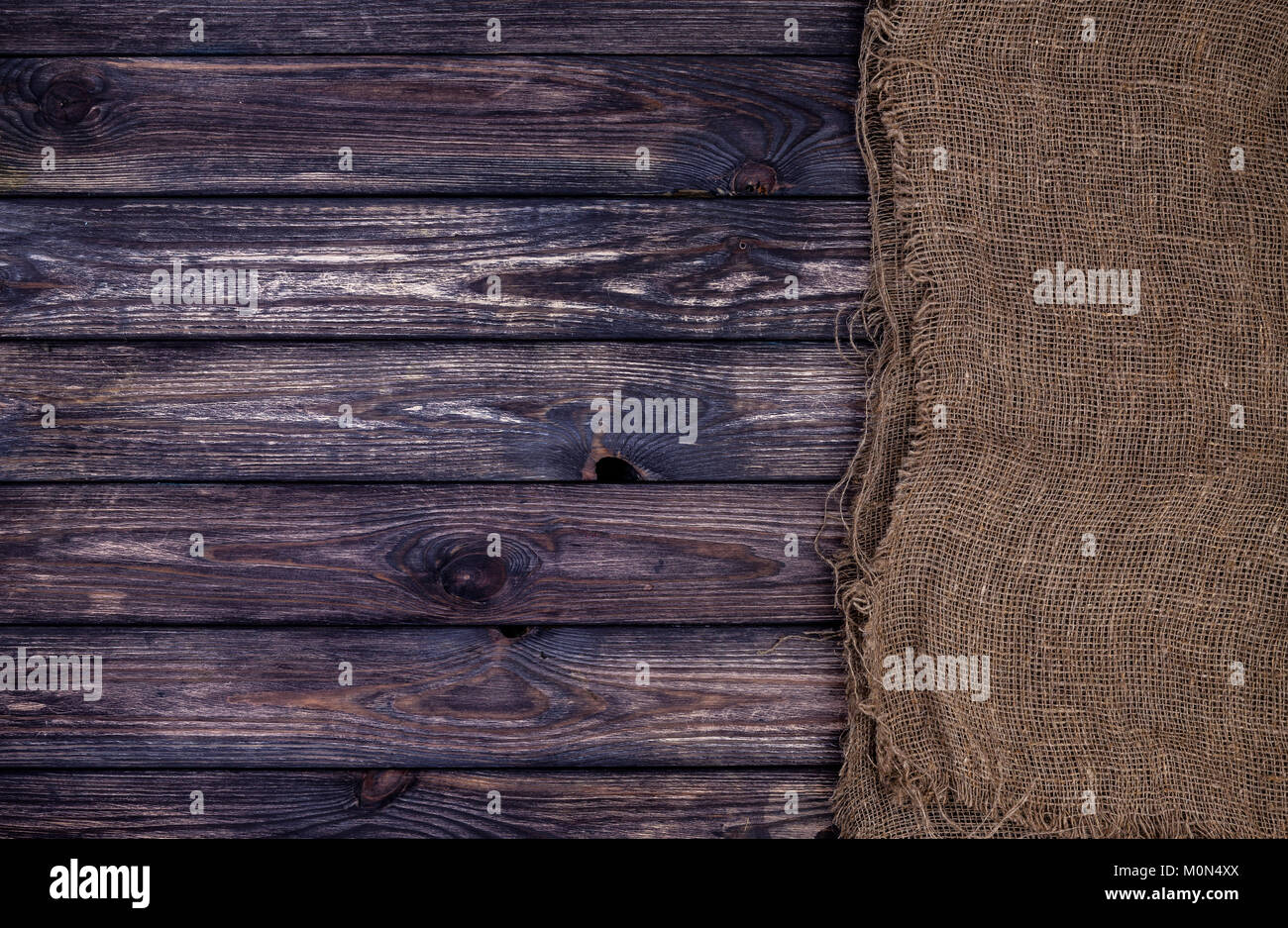 Dark wooden texture with burlap, wood and sack Stock Photo