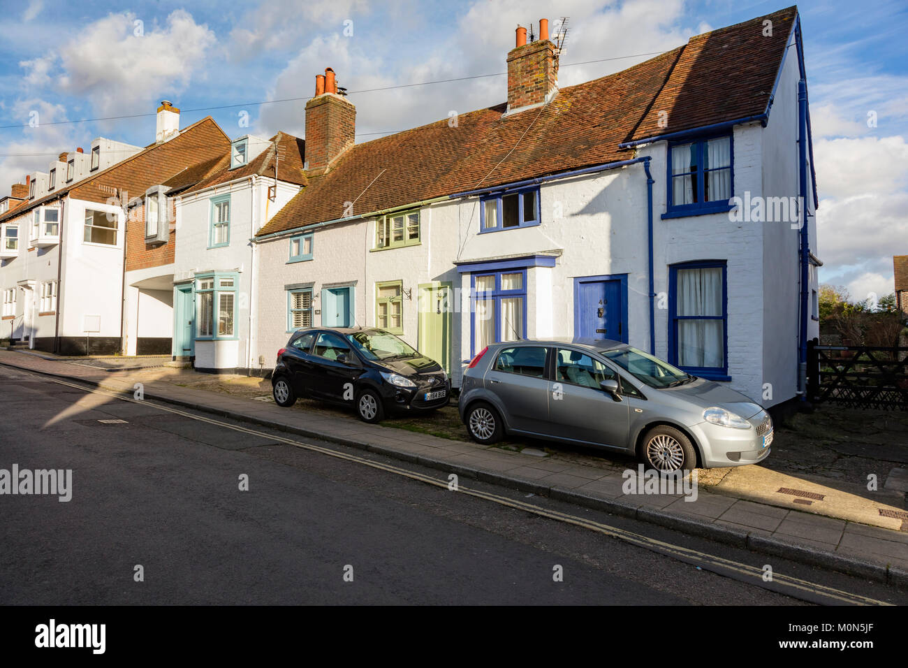 Parked cars in front of attractive cottages in Emsworth, Hampshire, UK