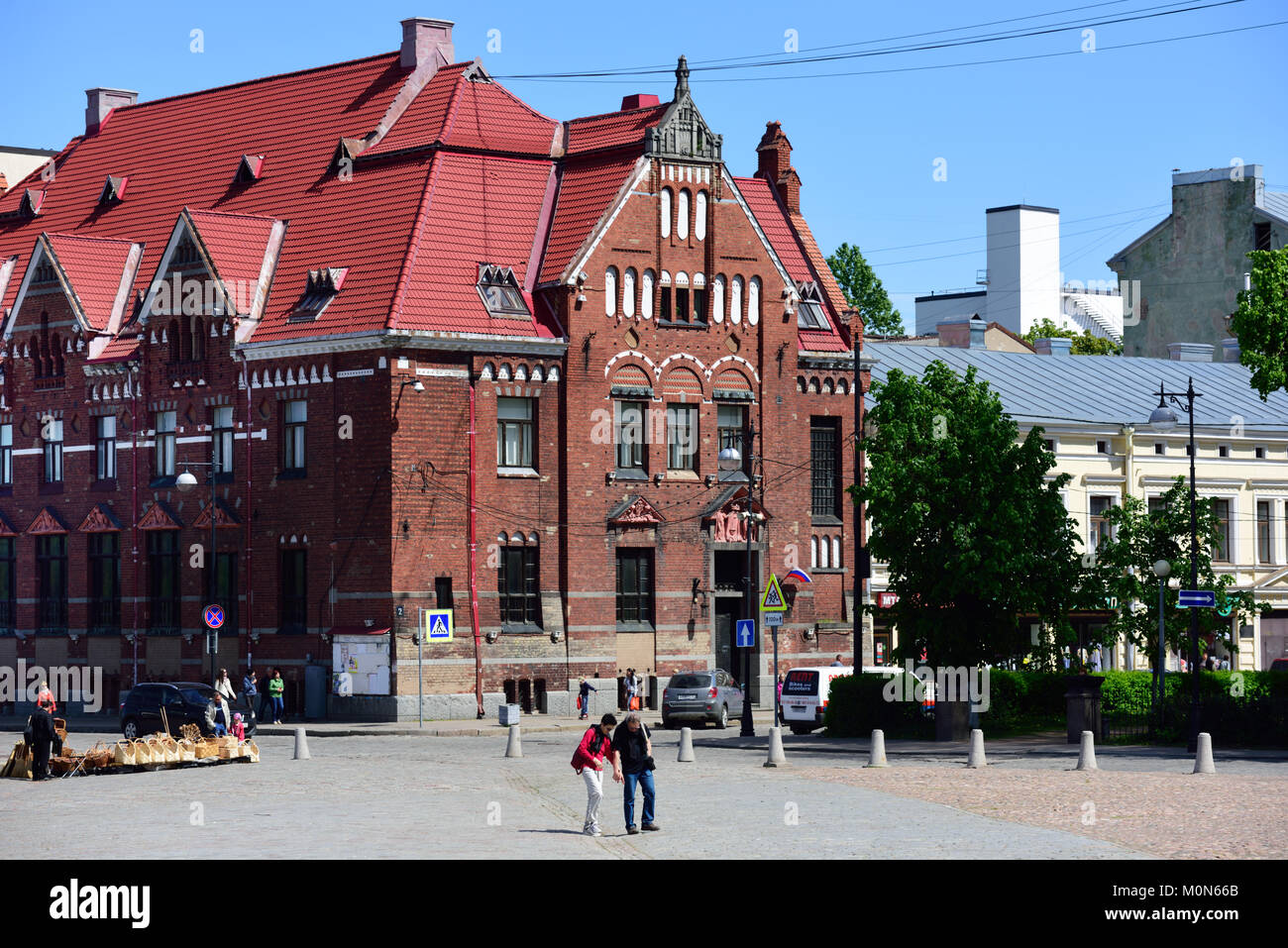 Vyborg, Leningrad oblast, Russia - June 06, 2015: People at the building of Suomen Pankki on the Lenin avenue. Built in 1910 by design of Carl Gustaf  Stock Photo