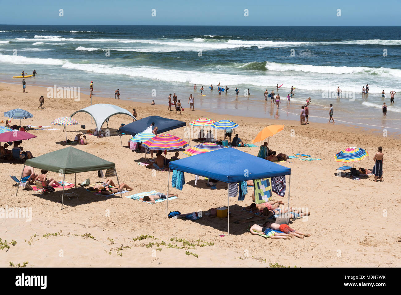 Glentana seaside resort on the Garden Route near George Western Cape, South Africa. December 2017. Holidaymakers on the beach with a view of the India Stock Photo