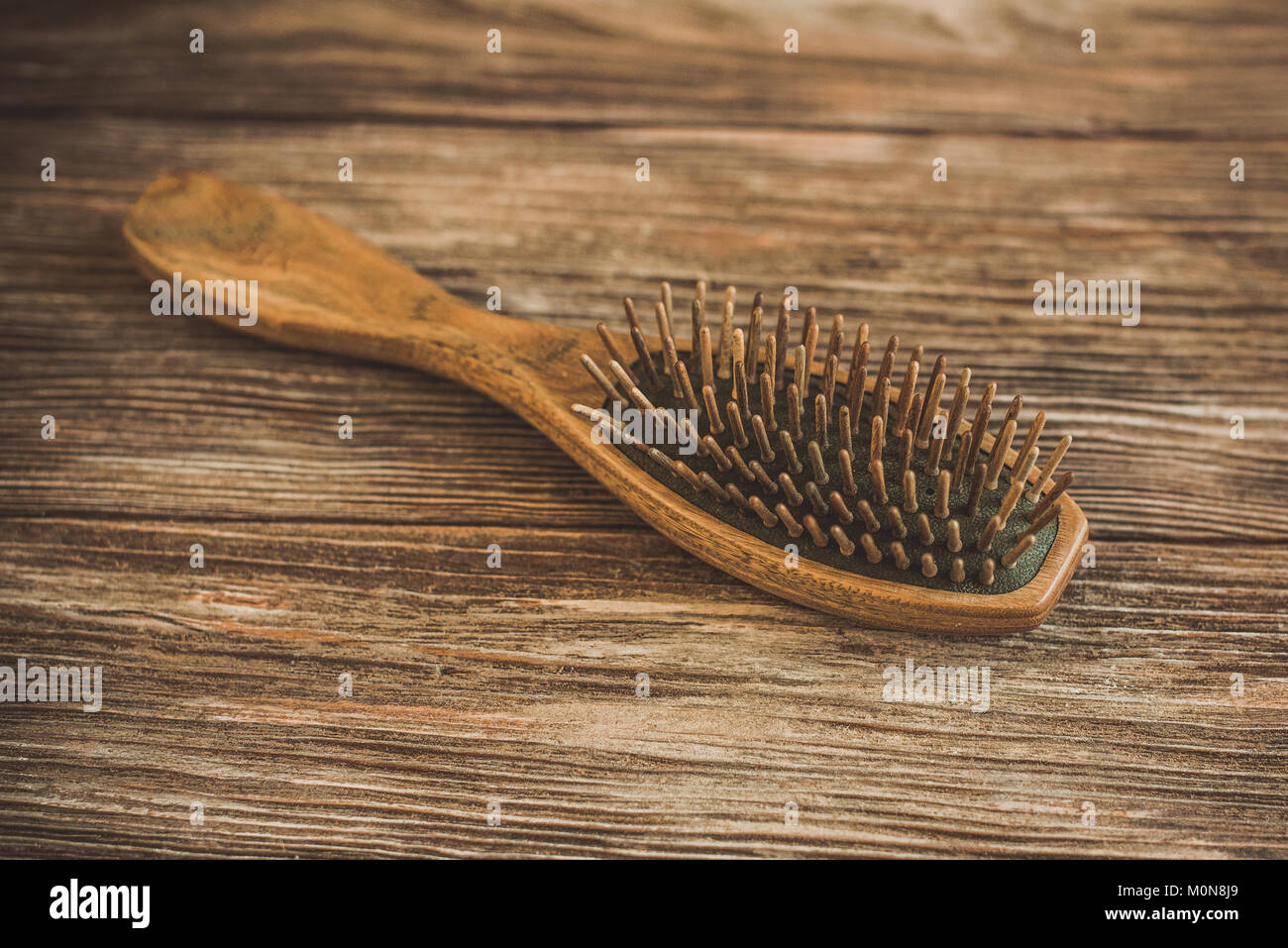 Haircare concept. Natural sandalwood comb closeup on wood background ...