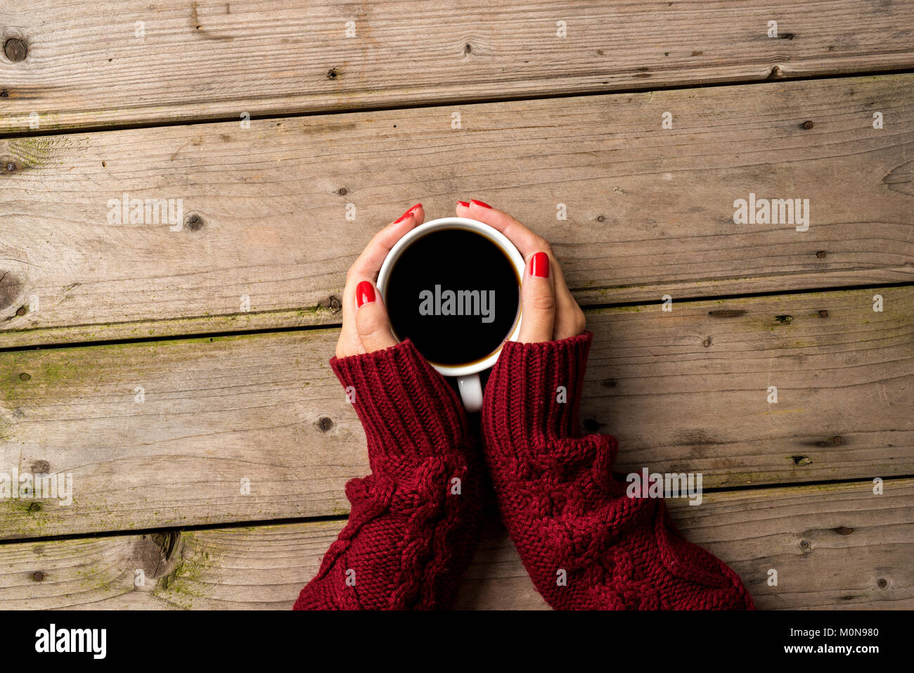 Female hands in warm sweater holding cup of coffee Stock Photo - Alamy
