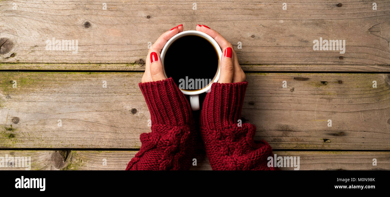 Female hands in warm sweater holding cup of coffee Stock Photo - Alamy