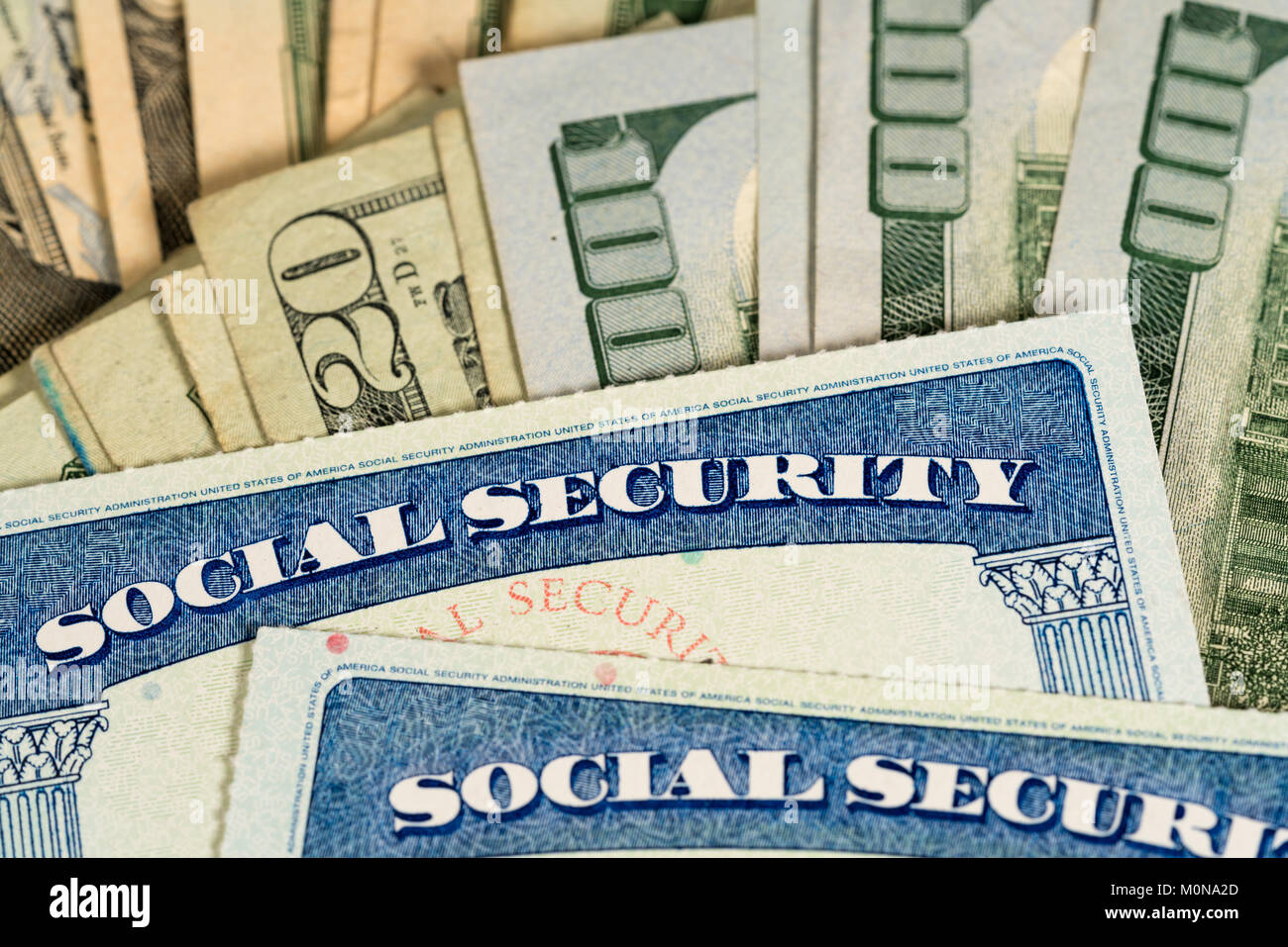 USA Social security cards laid on dollar bills Stock Photo